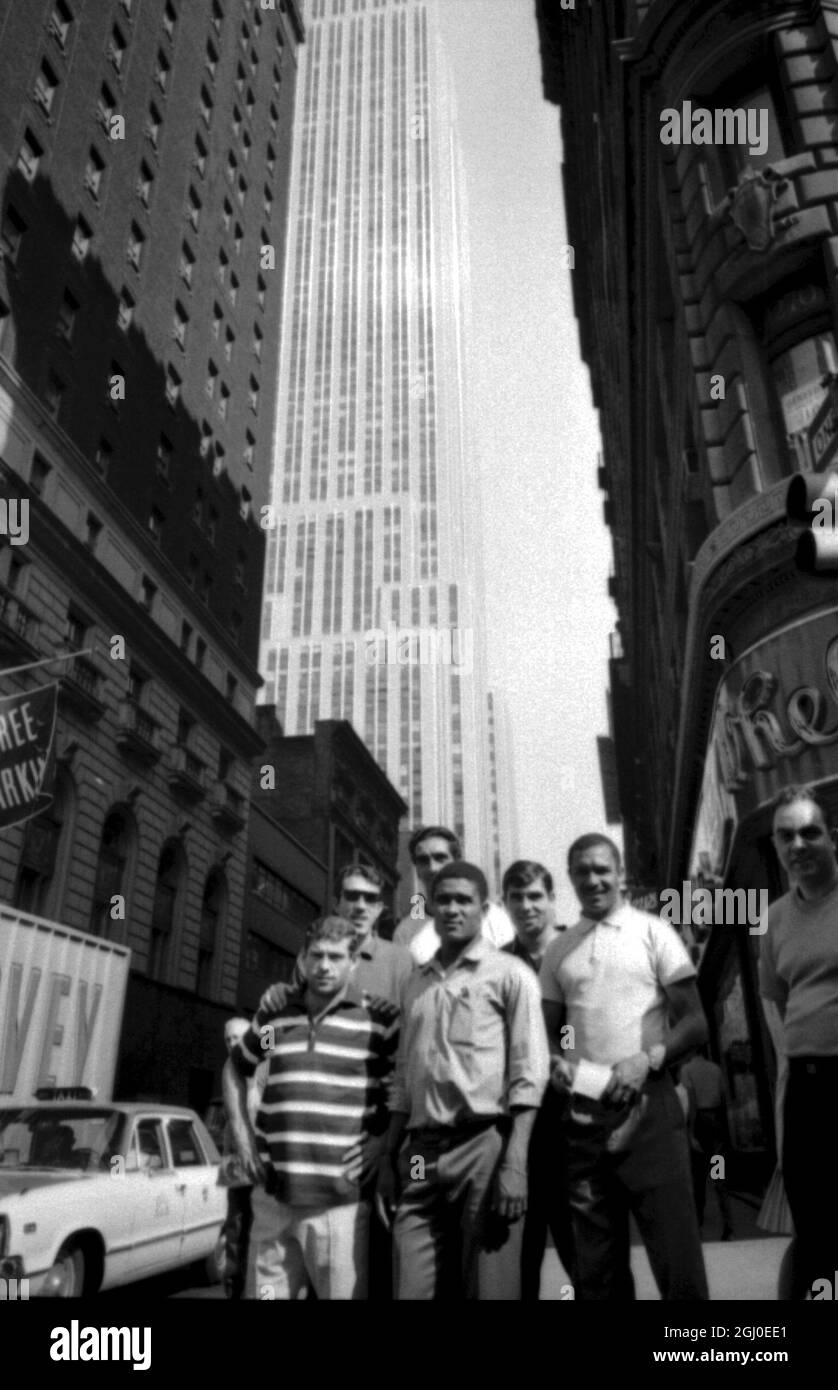 New York, USA - Star soccer team's from Portugal, Brazil and Greece are currently gathering in New York for the U.S. Cup of Champions Tournament to be held on three dates through 28th August at Randall's Island. Our picture shows members of the Portuguese team viewing New York from Broadway. Background the Empire State Building. Eusebio (Centre) Portugal's ace player is surrounded clock wise by Antonio Simoes; Augusto; Jose Torres; Graca and Mario Colunna. 18th August 1966 Stock Photo