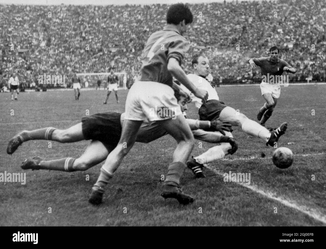 1962 World Cup Italy v West Germany Italian goalkeeper Buffon dives for a shot from Germany's Seeler with Italy's Salvatori (foreground) moving in during the World Cup match between Germany and Italy at National stadium, Santiago Chile. 1st June 1962. Stock Photo