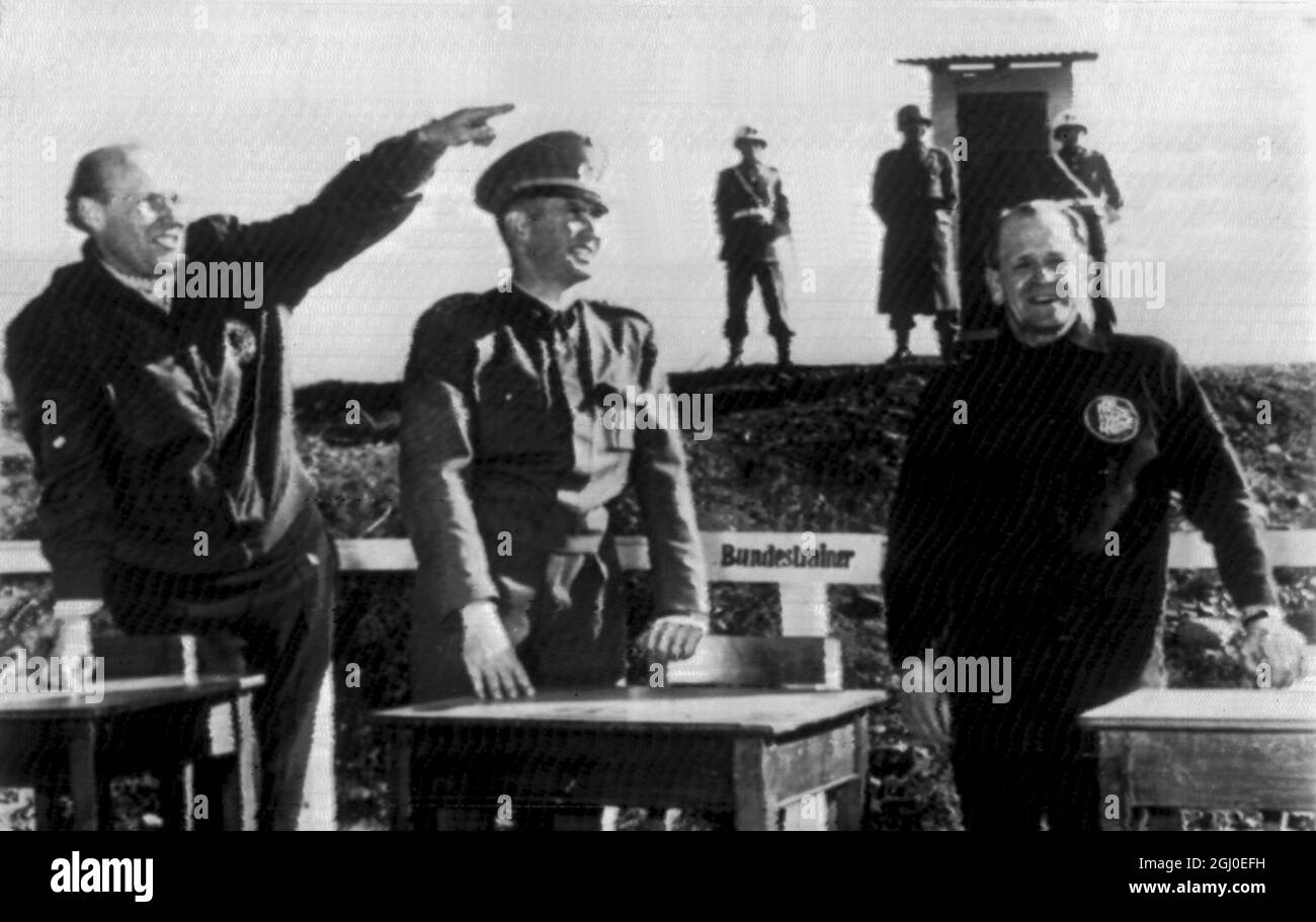 Here for the World football tournament in Santiago, Chile are German coach Herberger (right) and assistant Schoen (left) with captain Schoepke on a special rostrum for Bundestrainer inside the military school. 22nd May 1962. Stock Photo