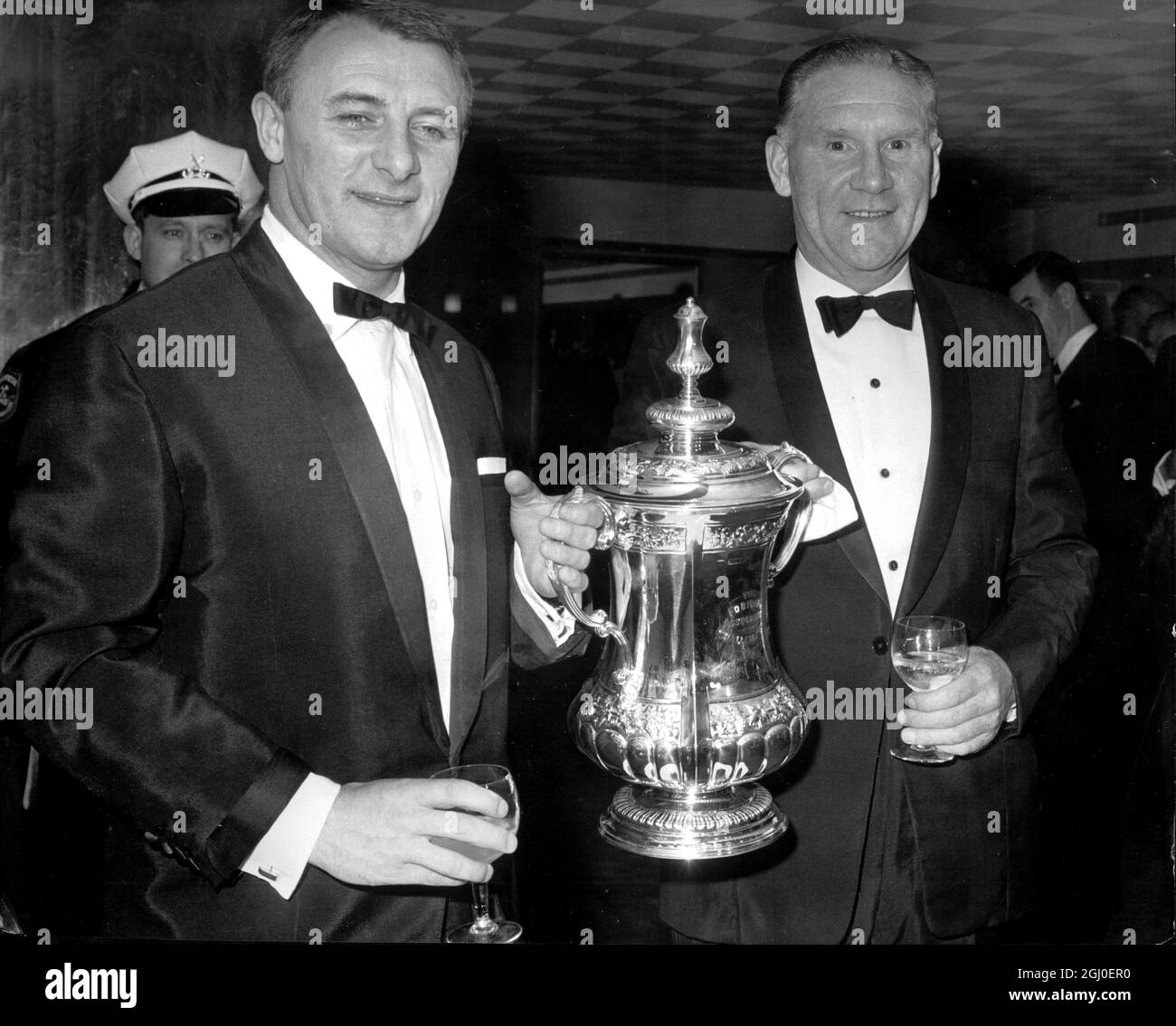 Chelsea Manager Tommy Docherty (left) and Tottenham Hotspur Manager Bill Nicholson hold the Football Association Cup between them and wonder which of them will be holding it after Saturday's FA Cup final between the two teams at Wembley. They are seen at the Boxing Dinner Evening in honour of the Chelsea and Spurs finalists in the London Hilton. 15th May 1967. Stock Photo