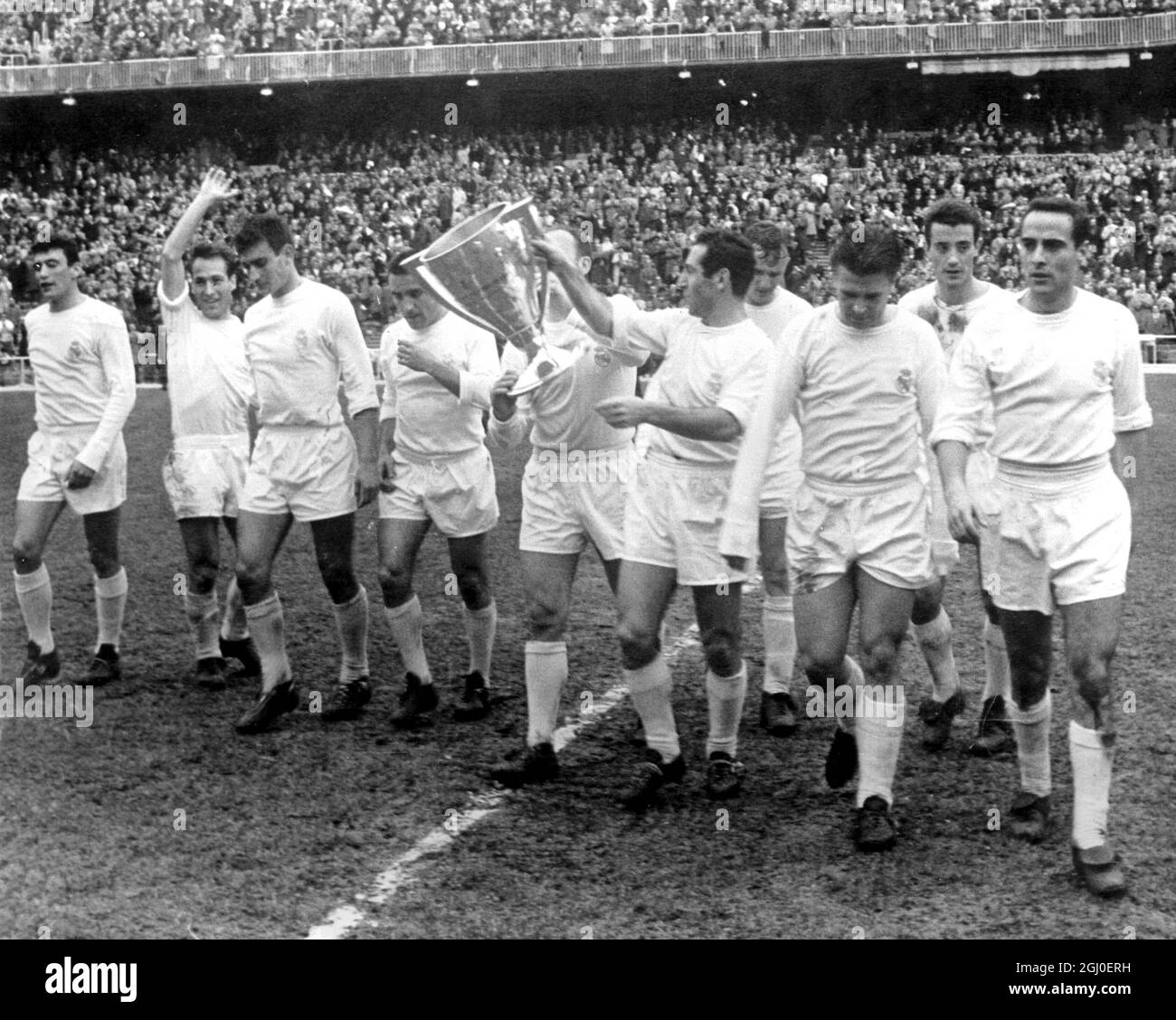 Real Madrid captain Gento and Di Stefano hold the Spanish League Championship trophy aloft as they and members of the team run a lap of honour round the Santiago Bernabeu stadium after beating Valenica 4-1. 5th April 1962. Stock Photo