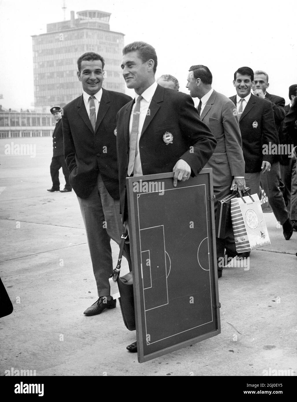 The Hungarian World Cup footballers arrived by air at Manchester airport. A valuable piece of luggage was the miniature instruction pitch on which they will plot their World Cup plans. Dezso Molnar holds on to the training board as the team arrive. 5th July 1966. Stock Photo