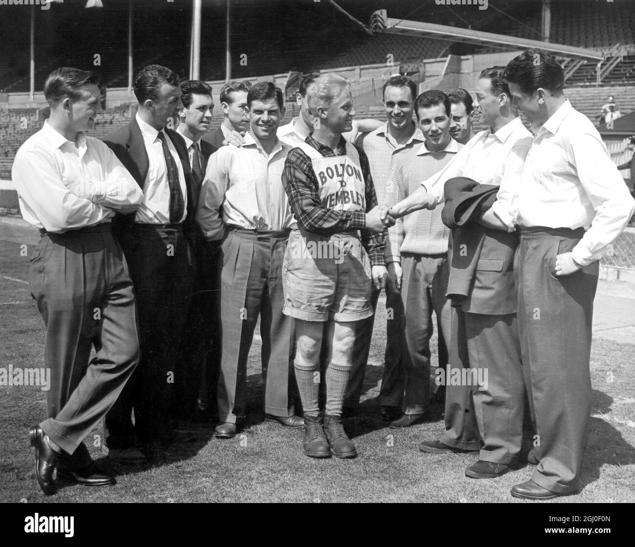 Members of the Bolton Wanderers football team are seen greeting Mr Roy Pilkington of Astley Bridge, Bolton who is one of their loyal band of supporters who have travelled to London to see the FA Cup final. Mr Pilkington walked all of the 195 miles to reach Wembley Stadium. 2nd May 1958. Stock Photo