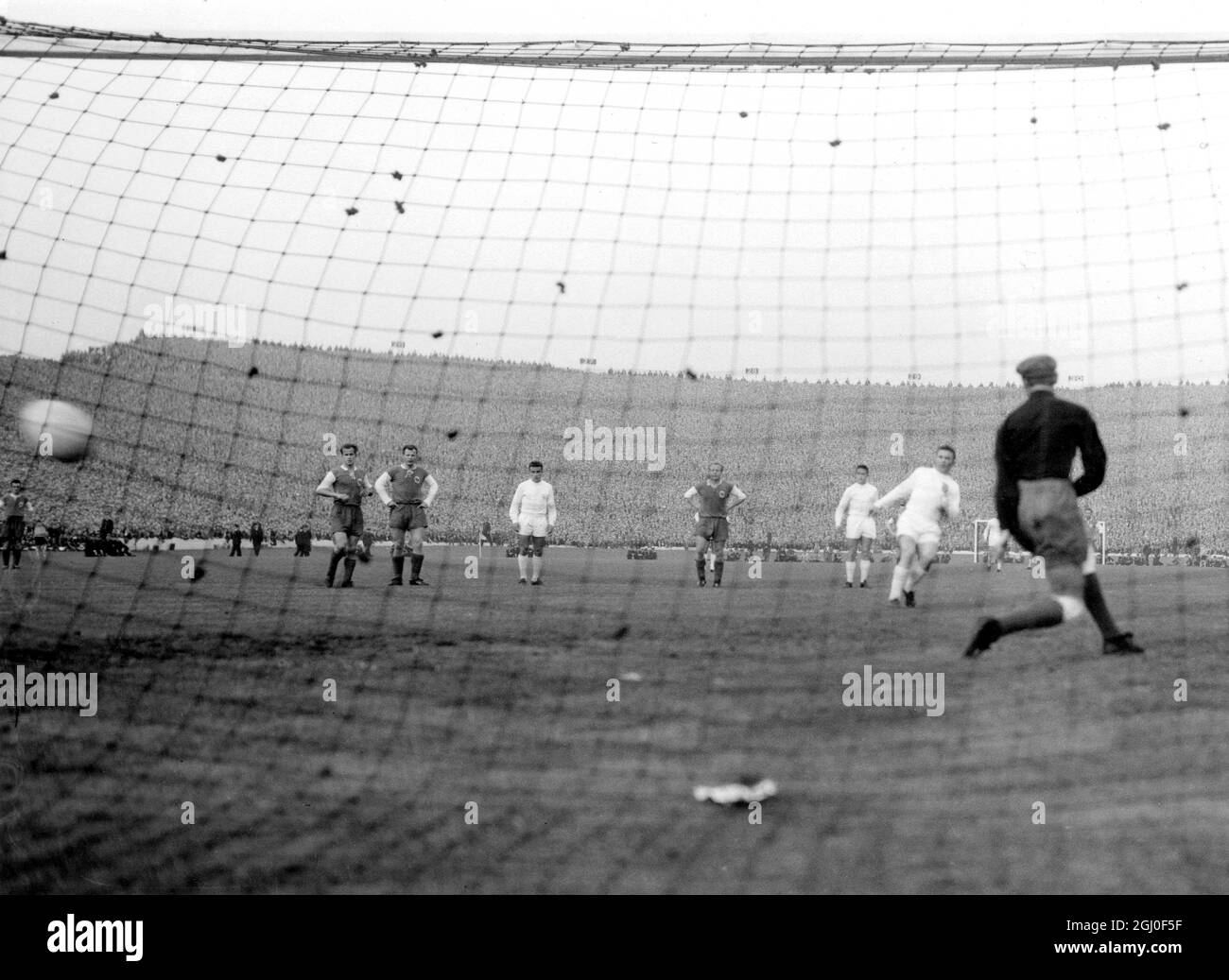 Hungarian Footballer Ferenc Puskas, who plays for Real Madrid (left of goalkeeper) flicks the ball into the net from a penalty kick to mark up Real Madrid's fourth goal against Eintracht Frankfurt during their Euorpean Cup Final match at Hampden Park. Real Madrid won 7-3 and won the European Cup for the fifth time. 18th May 1960 Stock Photo