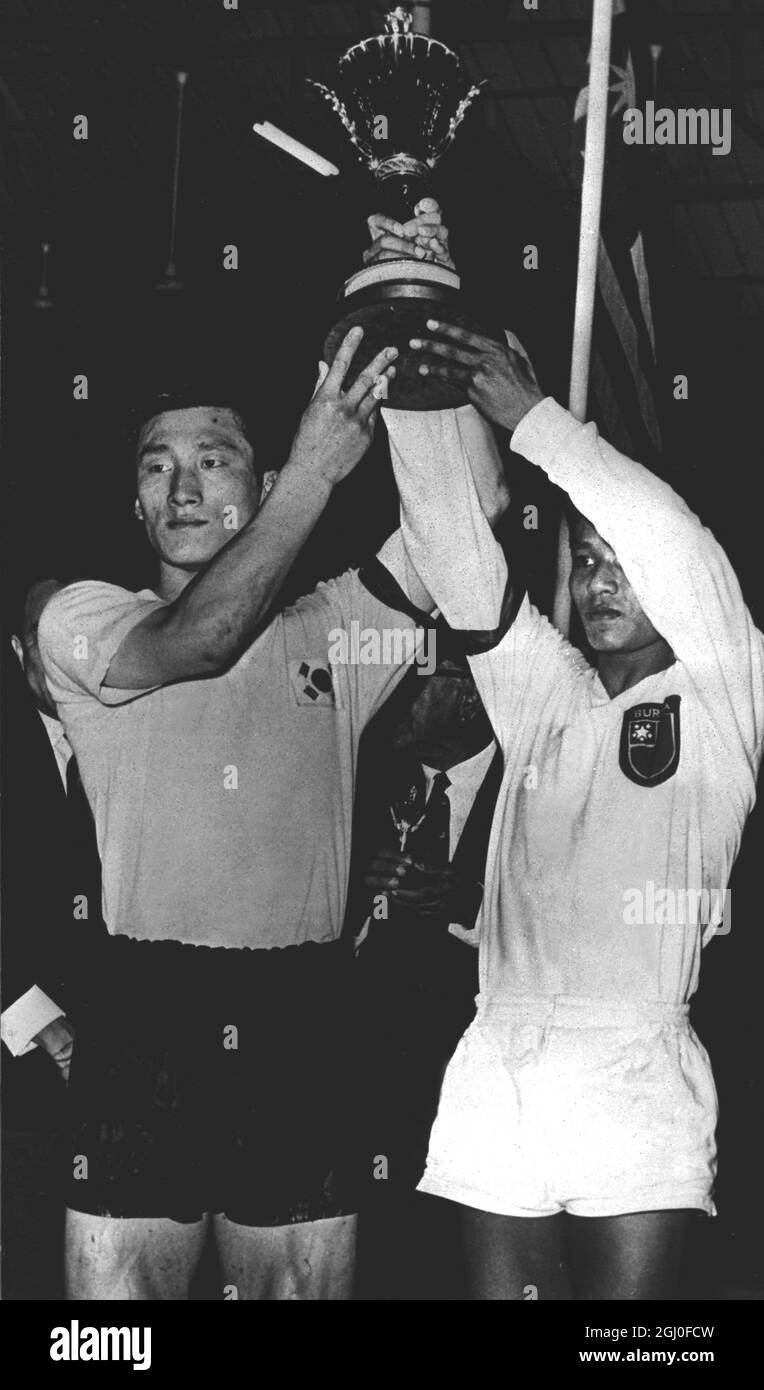 South Korean team captain Lee Seung Aun (left), and Burmese team captain Kyaw Thaung (right) hold aloft the Rahman Gold Trophy after the final in the Asian Soccer Championships at Penang's City Stadium, in Kuala Lumpur. The match ended in a draw and as a result of the toss of a coin, the trophy was given to the Burmese team to keep for sixth months and then handed over to the South Korean team to hold until the next championship match. 28th April 1963. Stock Photo