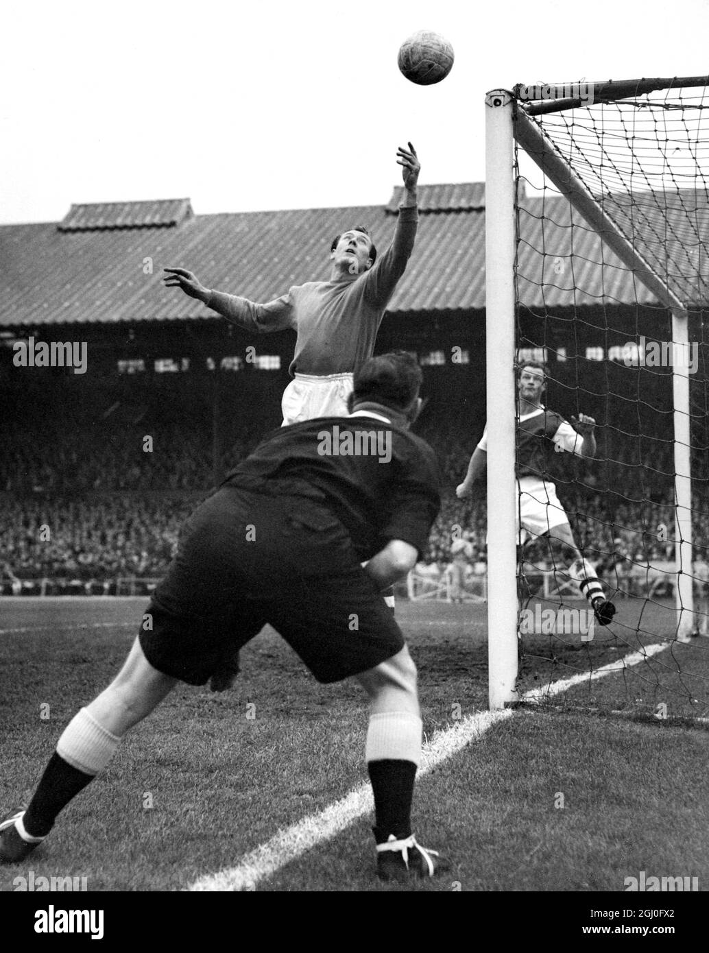 Chelsea v Arsenal Watched by referee Mr H Webb of Leeds, Jack Kelsey, the Arsenal goalkeeper makes a save during the match at Stamford Bridge. 26th October 1957 Stock Photo
