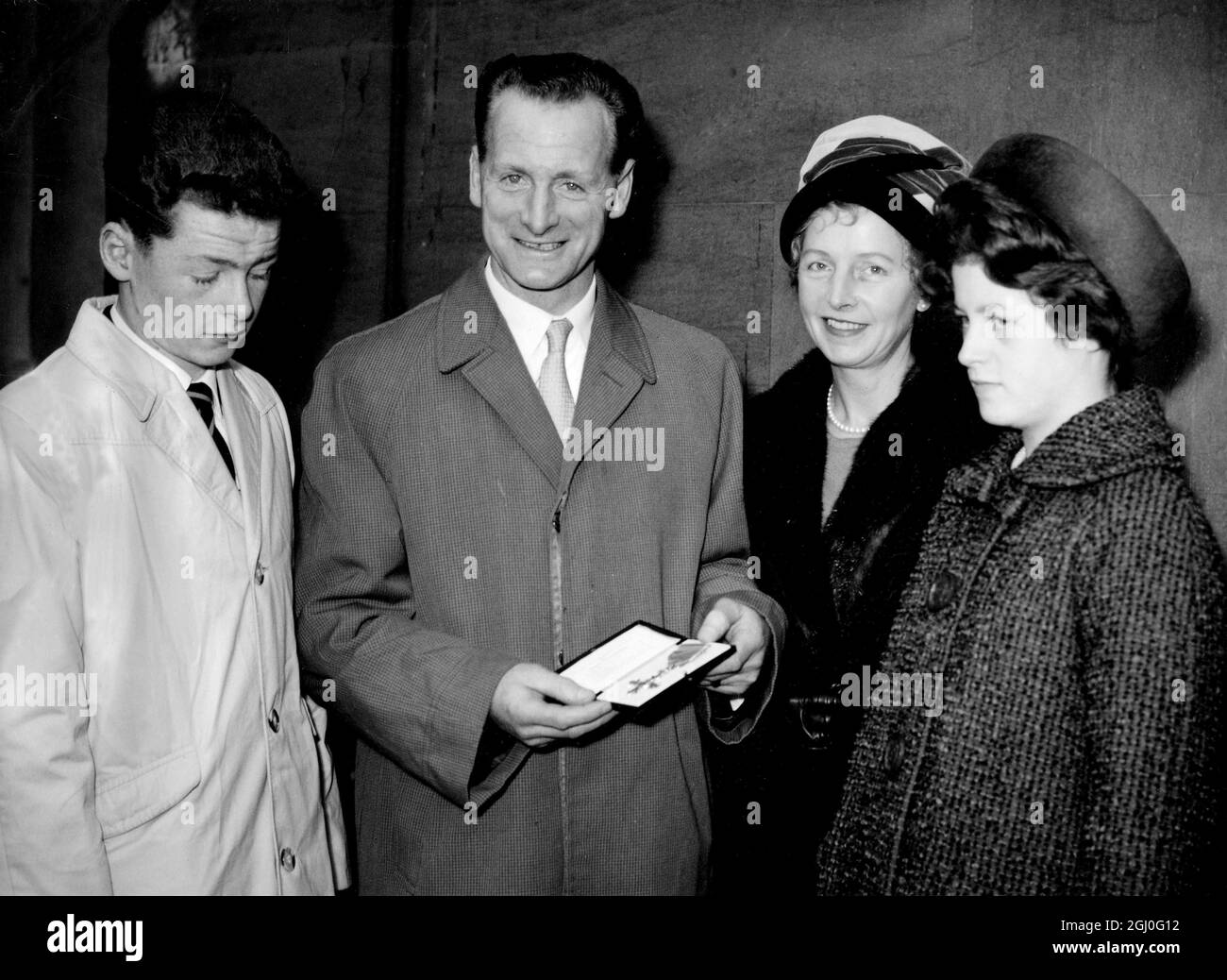 Tom Finney receives the O.B.E from Queen Elizabeth. Photo shows the former England and Preston North End player, with his 13 year-old daughter, Barbara, and his 11 year old son, Brian, after the ceremony at Buckingham Palace. 24th October 1961 Stock Photo