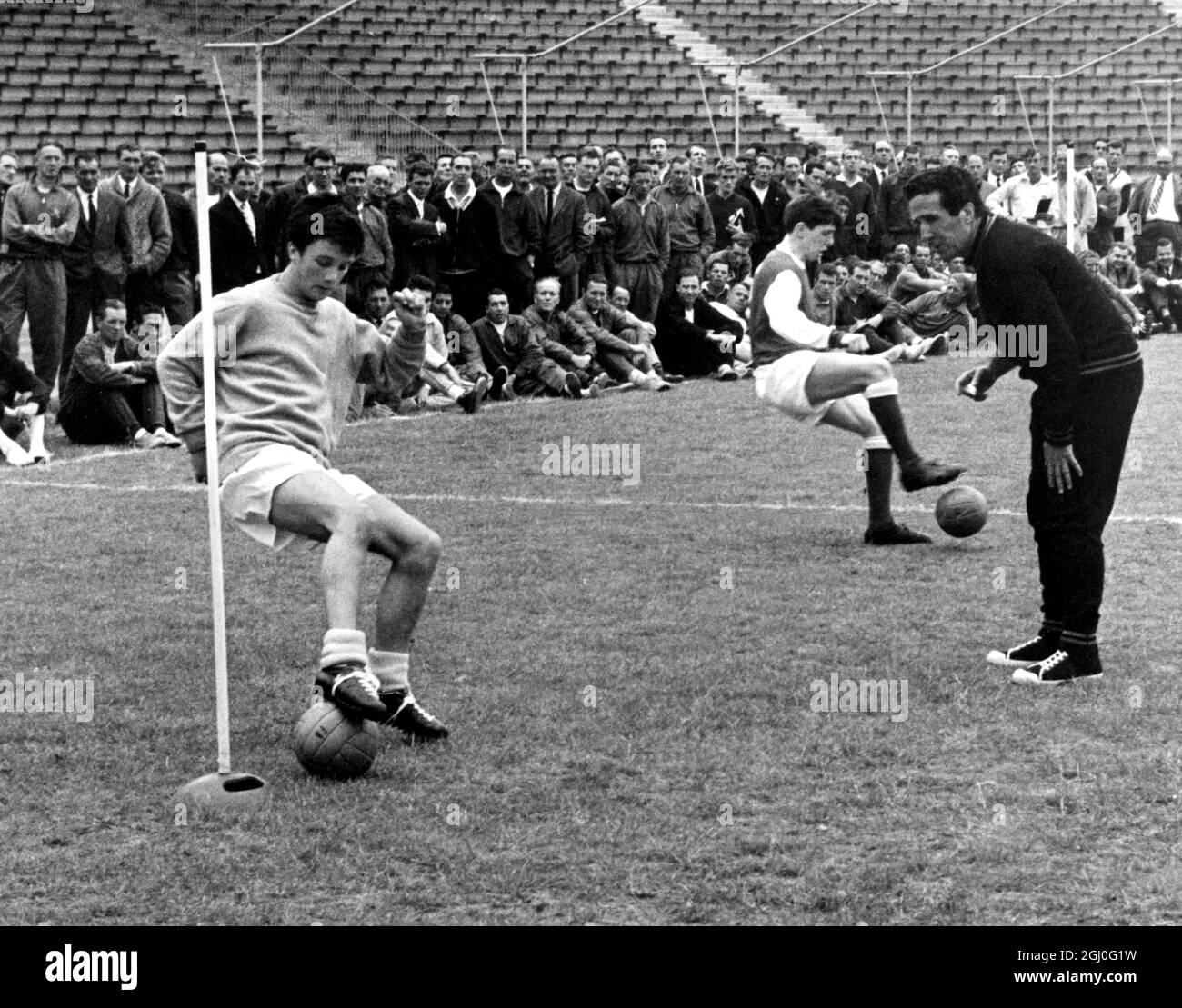 Helenio Herrera (right) of Inter-Milan demonstrates his training methods to British managers and coaches yesterday. The course was organised by the Football Association at the National Recreation Centre, Crystal Palace. 7th July 1965 Stock Photo