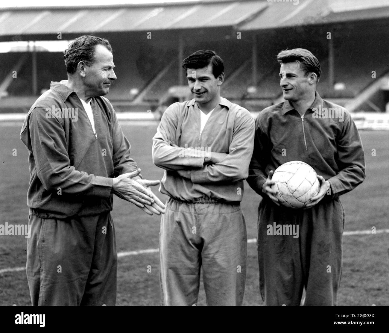 England train at the White City Stadium. Photo shows: England team manager, Walter Winterbottom (left), with new caps, Stan Anderson (centre) and Roger Hunt (right). 3rd April 1962 Stock Photo