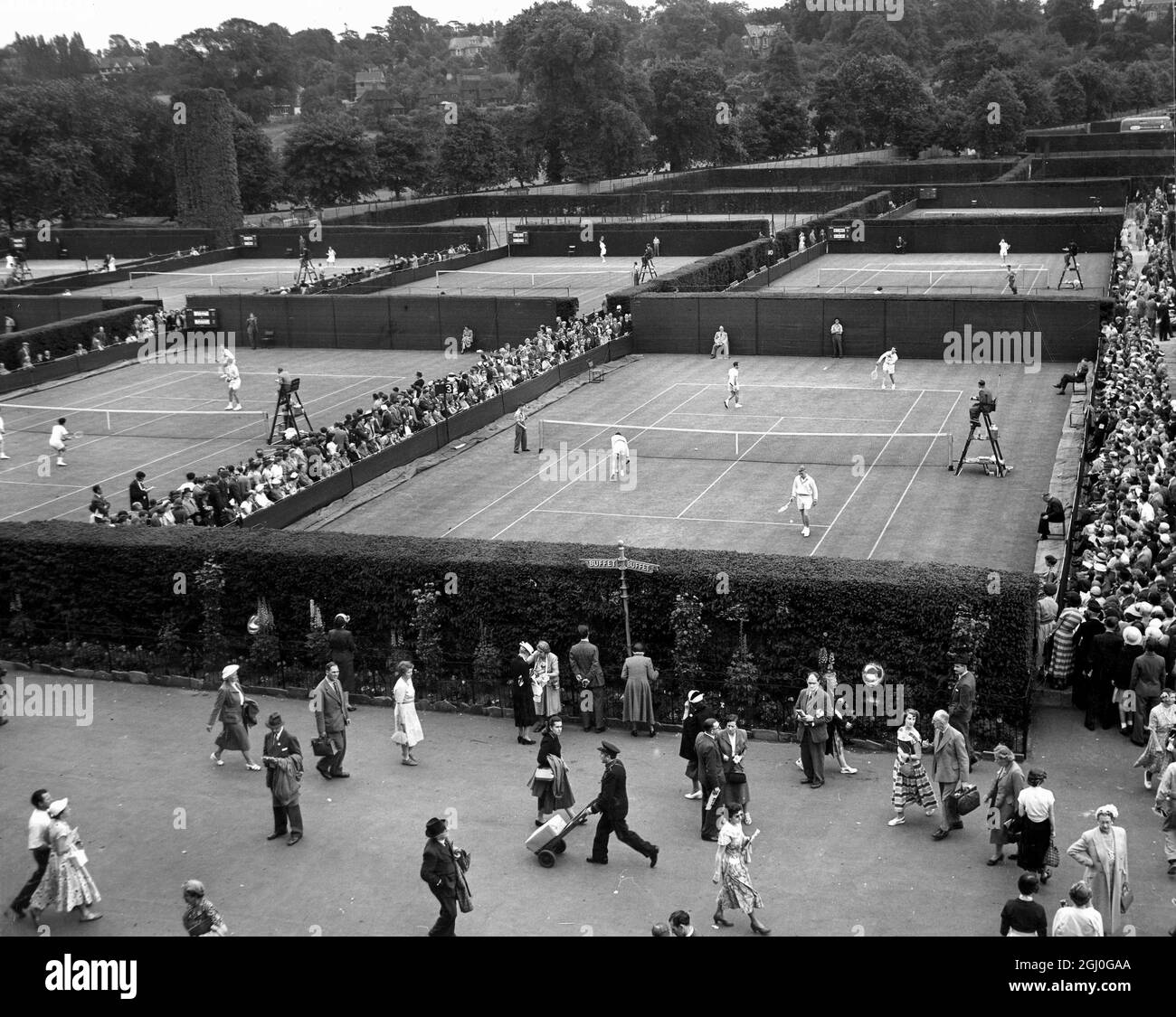 A general view of play in progress on the outside courts at Wimbledon today, when the first of the Ladies matches were played. 23rd June 1953 Stock Photo