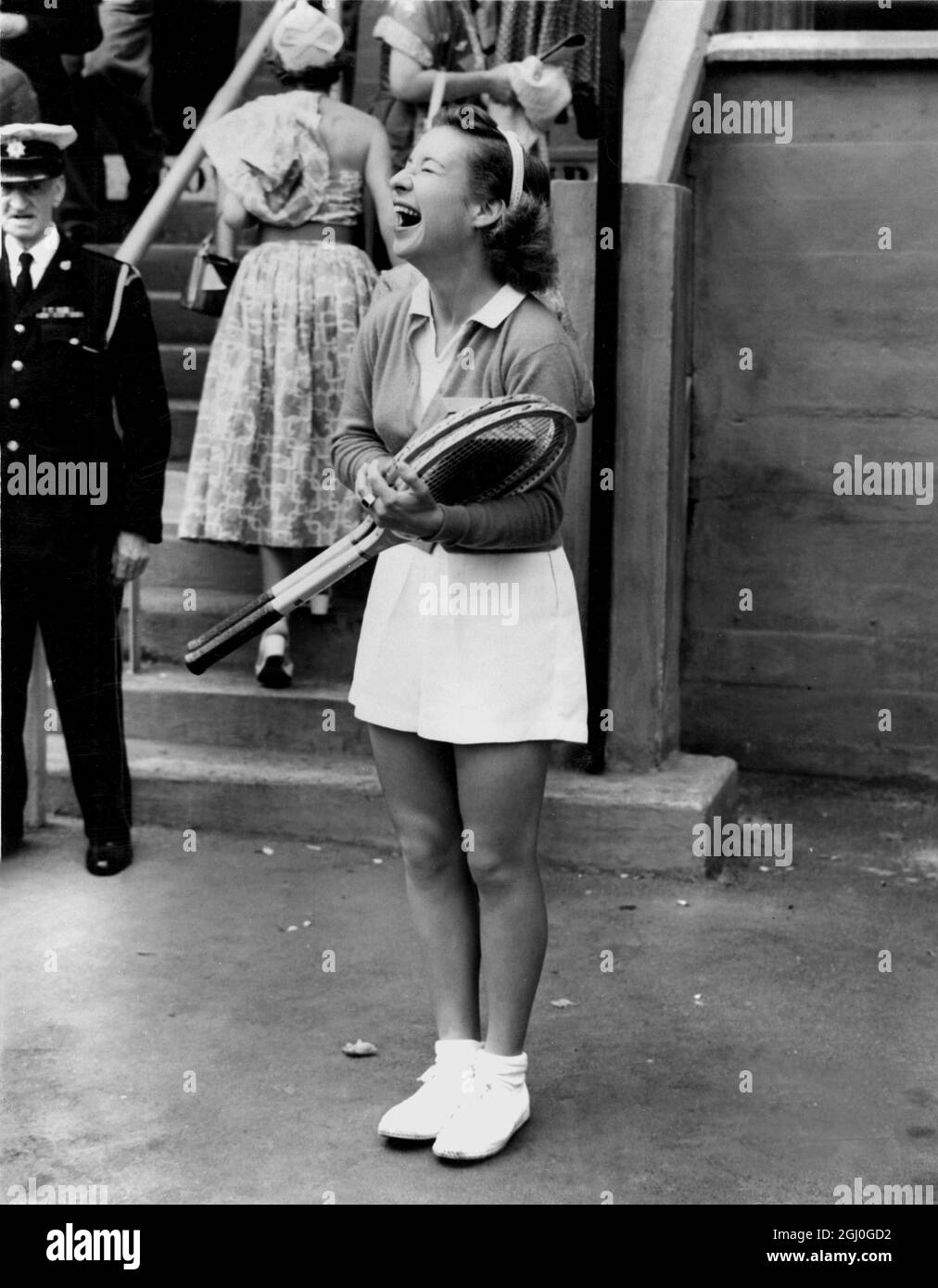 Maureen Connolly (Little Mo) of America, enjoys a joke on her way to courts at Wimbledon, where she is defending her title as Women's singles champion. 24th June 1953 Stock Photo