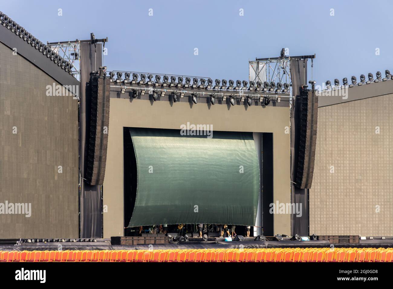 Empty outdoor concert stage. scene for festival, show, performance or presentation. Podium stage with truss, music and light equipment at day. Stage Stock Photo
