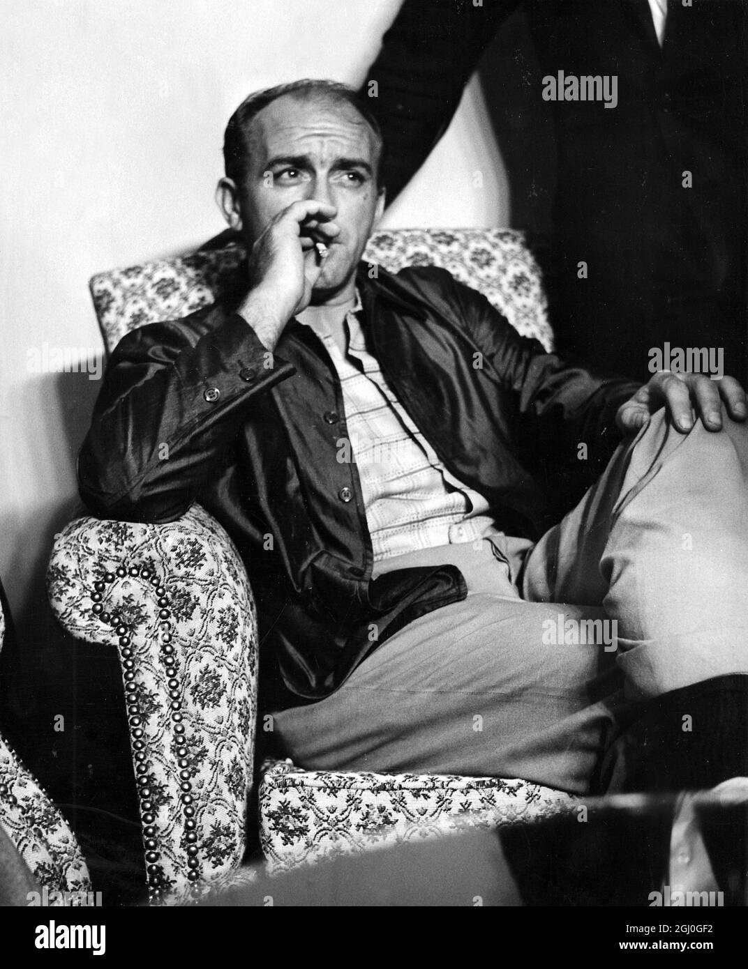 Alfredo Di Stefano, Real Madrid's star centre-forward, puffs a cigarette nervously at the Spanish Embassy in Caracas after his release by members of a communist-Castroite terrorist organisation, who had held him captive for 56 hours in a frank bid for world publicity. Di Stefano was the subject of a city wide manhunt involving more than 500 detectives, He was kidnapped from his hotel room before dawn on Saturday by terrorists posing as policemen. 26th August 1963 Stock Photo