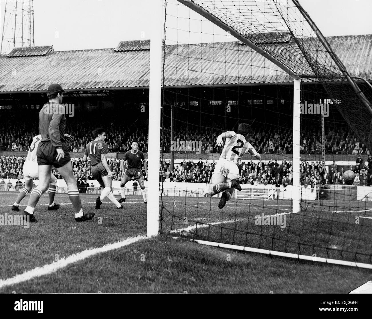 Chelsea v Stoke City Stoke goalkeeper, Leslie caught out of position as Tambling (Chelsea's outside-left) shoots past Asprey (Stoke's right-back), who makes a desperate effort to save on the line during the match at Stamford Bridge. 17th October 1964 Stock Photo