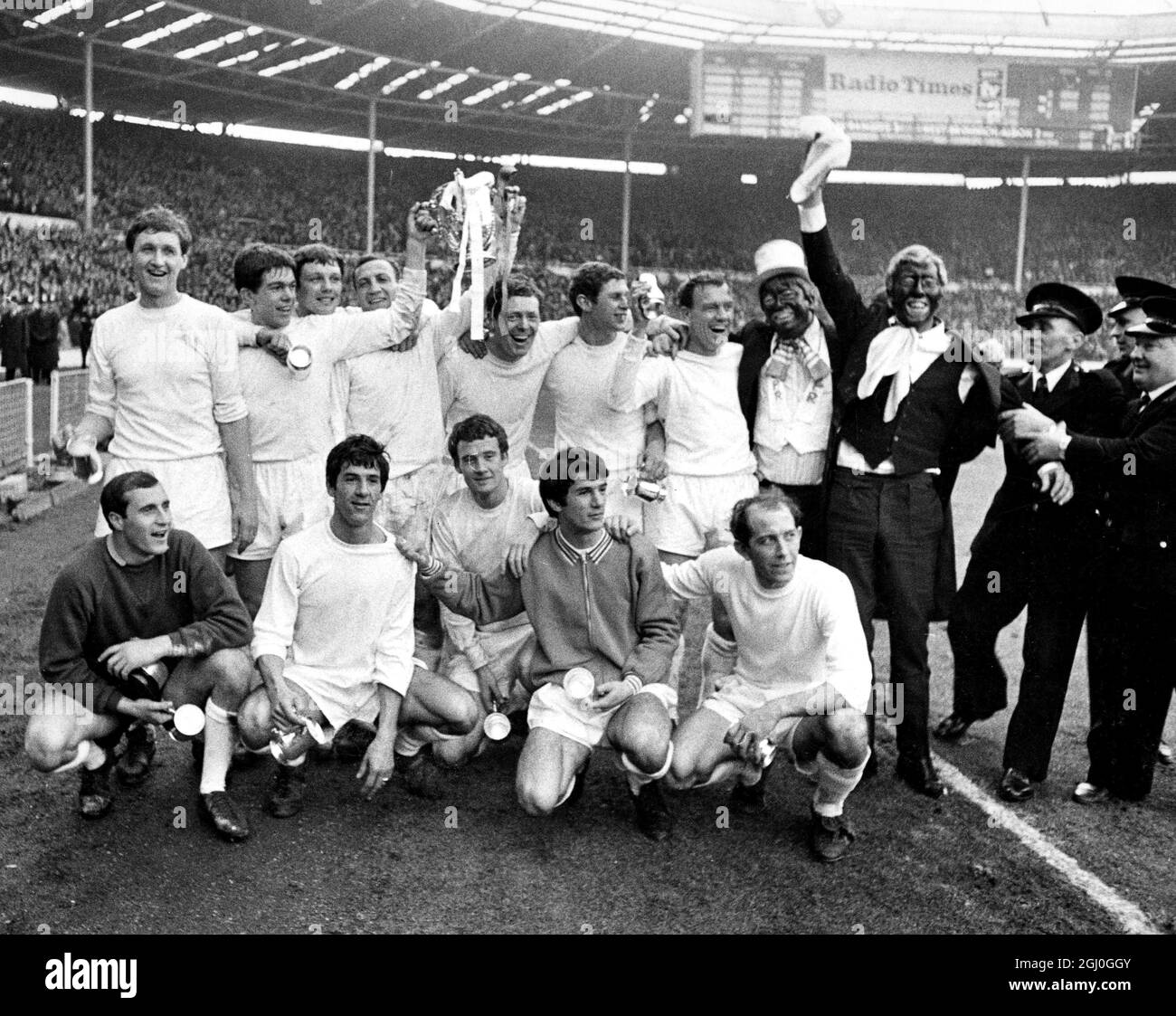 1967 League Cup Final QPR v West Bromwich Albion Two enthusiastic spectators dressed as 'minstrels' join the QPR team as they pose for photos after their victory in the league cup final against West Bromwich Albion. 4th March 1967 Stock Photo