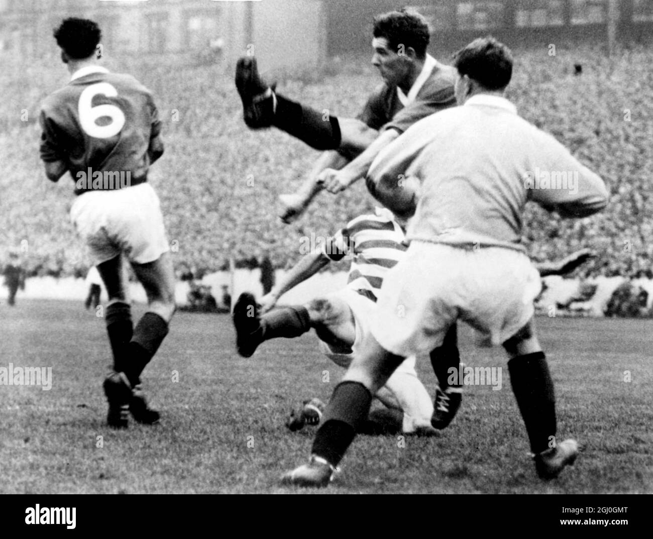 1960 Scottish League Cup Final Glasgow Rangers v Kilmarnock at Hampden Park. Rangers right-back, Shearer (centre kicking - kicks away from his goal as Black of Kilmarnock (striped shirt on ground) goes sprawling during yesterday's 29th Scottish League Cup final. The other two players in the photo are Baxter (No6) and goalkeeper, Niven (right) both of Rangers. 30th October 1960 Stock Photo
