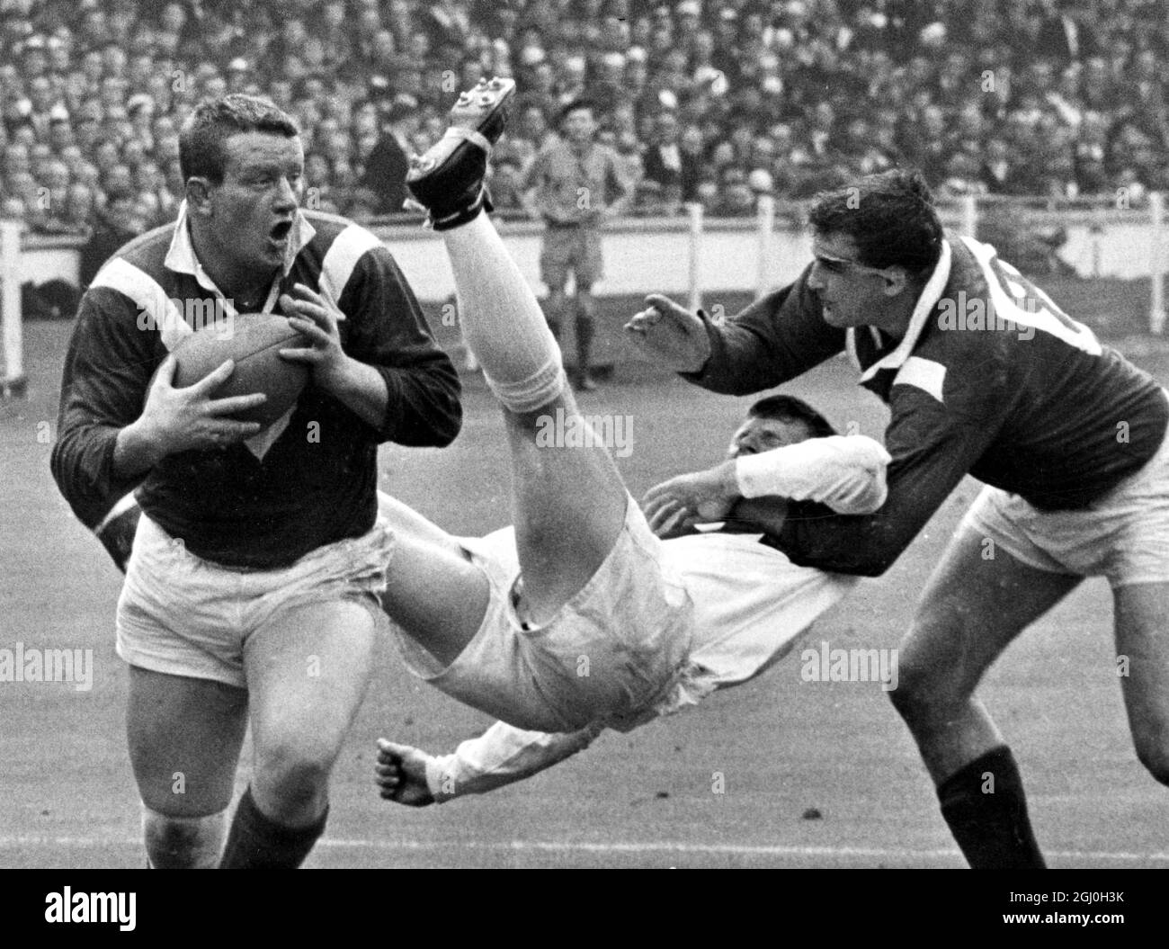 Bill Sayer, The ST. Helen's hooker ends up in mid air after attempting to stop Wigan's left centre three-quarter and skipper Eric Ashton during the Rugby League Challenge Cup Final at Wembley Stadium this afternoon (Saturday). Other Wigan player in the picture is front row forward Danny Gardiner. 1966 Stock Photo