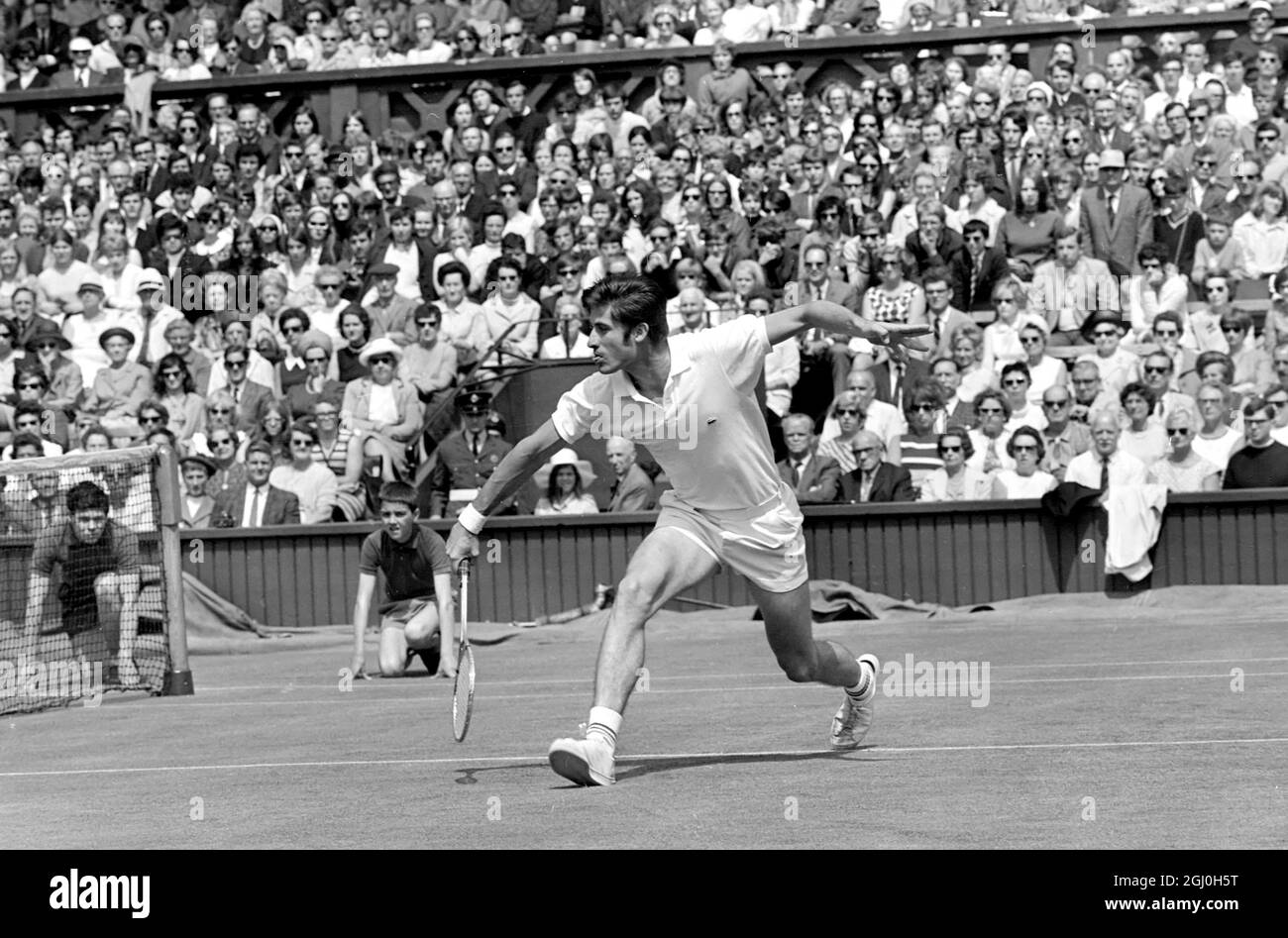 London: Charles Pasqarell, of Puerto Rico, in action against Pancho Gonzales, of Los Angeles, in the Mens Singles of the Wimbledon Tennis Championships. 25 June 1969 Stock Photo