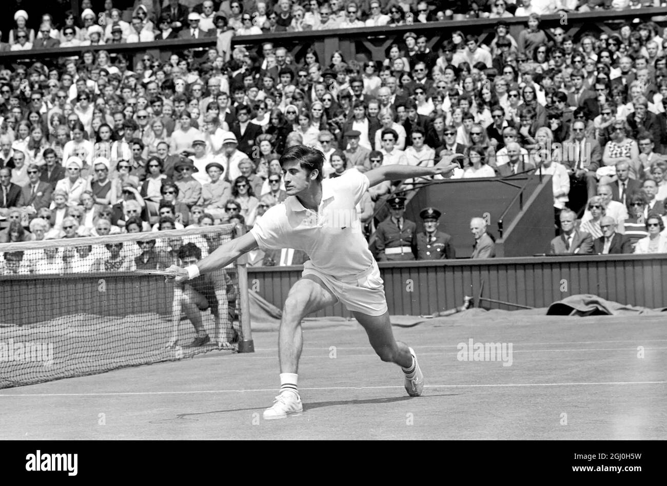 London: Charles Pasqarell, of Puerto Rico, in action against Pancho Gonzales, of Los Angeles, in the Mens Singles of the Wimbledon Tennis Championships. 25 June 1969 Stock Photo