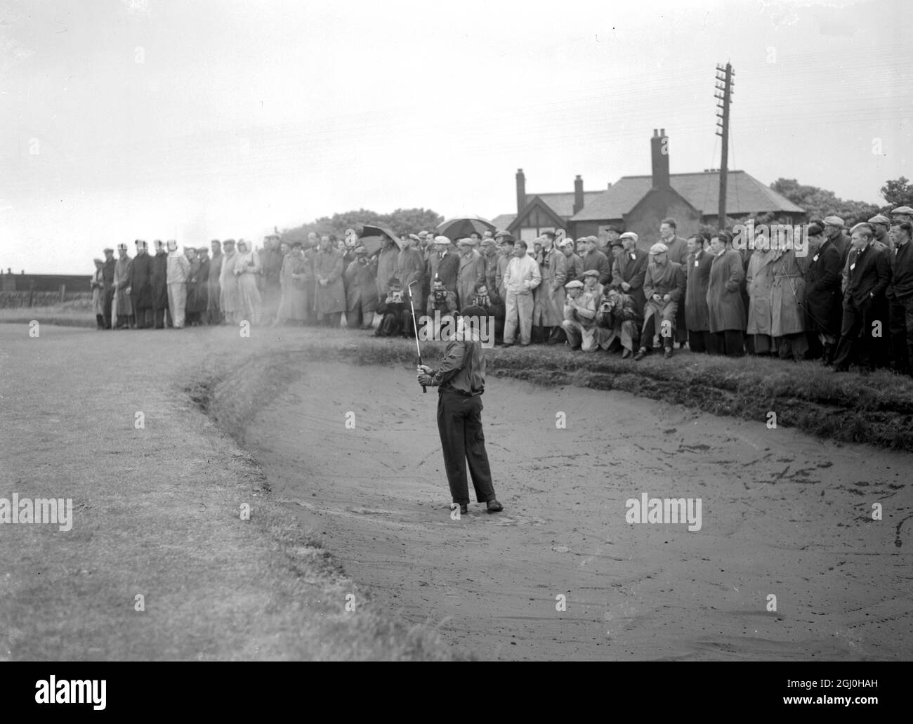 Frank Stranahan, the American favourite fot the British Amateur Golf Title, which he has won twice,had break through a terrific challenge by 53 year old Yorkshireman Joe Gent to win his second round game at the 21st hole at Prestwick yesterday. Stranahan playing from the bunker. 28 May 1952 Stock Photo