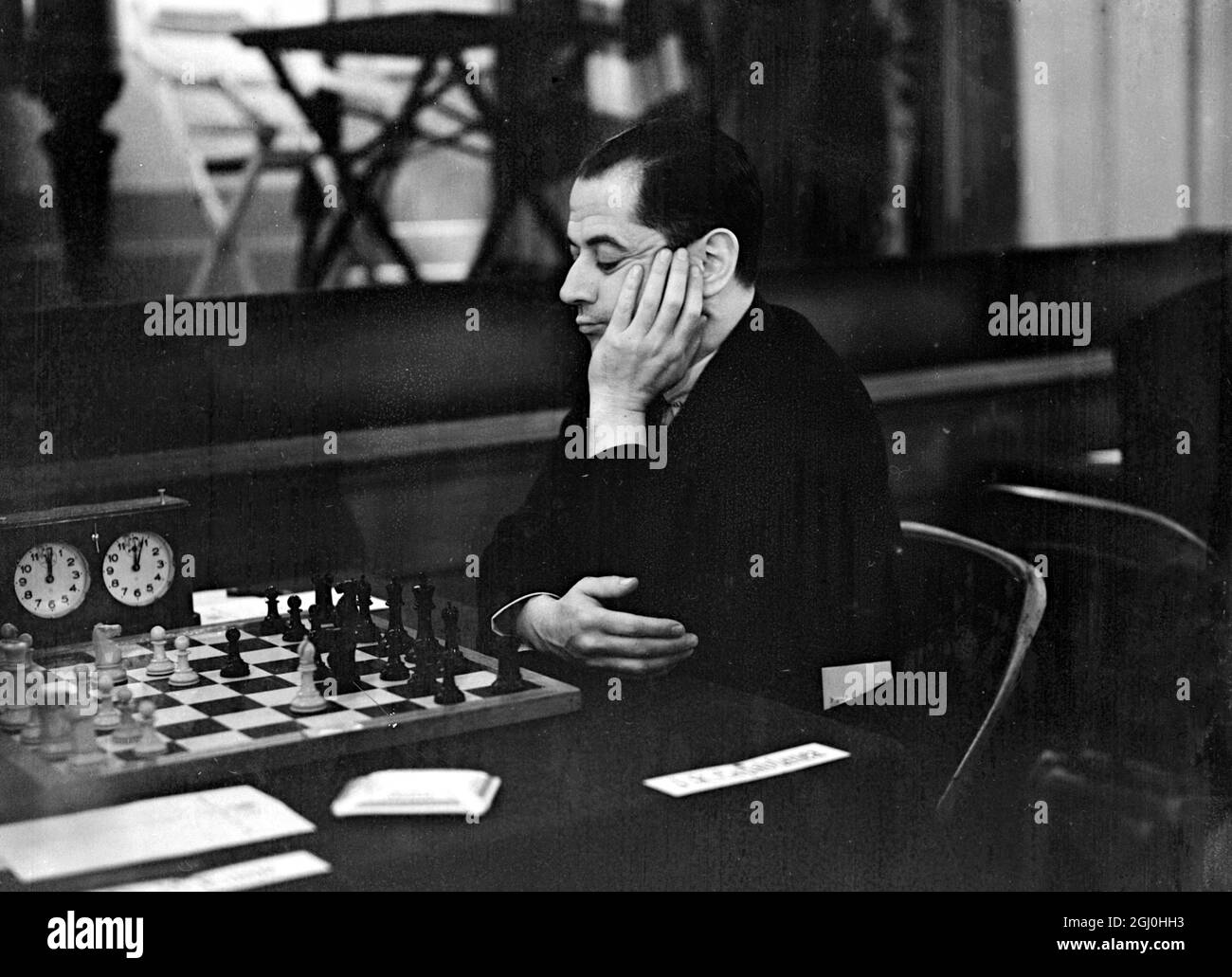 Senor Capablanca ( ex-champion chess player of the world ) with Dr Max Euwe ( Dutch professor ) and Sele Flohr of Czechoslovakia ( twice winner of similar contests ) and others of the worlds' most distinguished chess masters are taking part in the Chess Tournament which has opened at Hastings - an interesting competitor is M Botwinnik champion of all Russia the first representative player from that country to take part in a British tournament since the Revolution - photo shows Senor J B Capablanca concentrating on his game at Hastings. December 27th 1934 Stock Photo