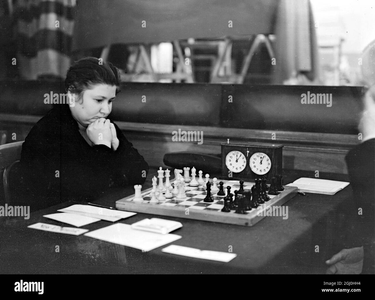 Senor Capablanca ( ex-champion chess player of the world ) with Dr Max Euwe ( Dutch professor ) and Sele Flohr of Czechoslovakia ( twice winner of similar contests ) and others of the worlds' most distinguished chess masters are taking part in the Chess Tournament which has opened at Hastings - an interesting competitor is M Botwinnik champion of all Russia the first representative player from that country to take part in a British tournament since the Revolution - photo shows Miss V Menchik ( German champion ) studying her game at Hastings December 27th 1934 Stock Photo