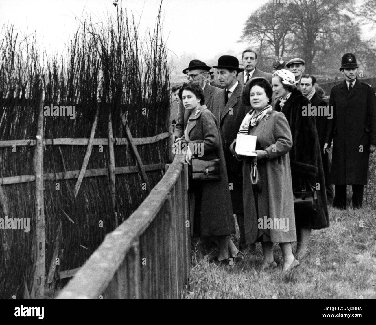 The Queen Elizabeth II with The Queen Mother down on the course watching hurdle racing with them is Lord Lewes and Sir Kenneth Gibson Clerk of the Course Sandown Park Steeplechase November 1953 Stock Photo