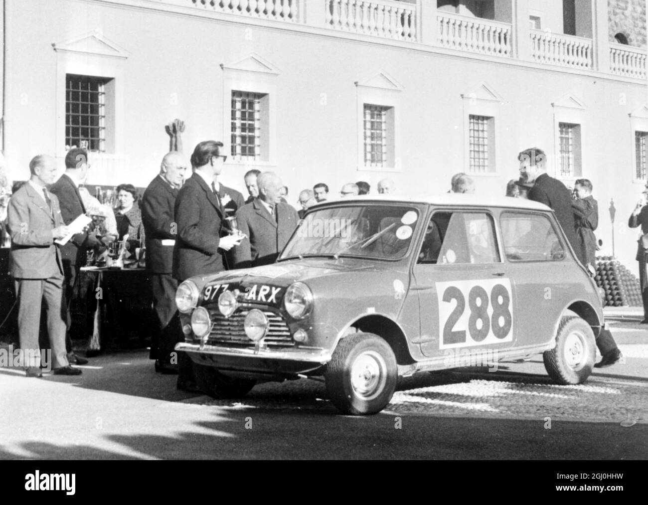 Monte Carlo, Monaco: Morris car 288 and the driver (standing near bonnet, profile, holding cup) and co-driver (at the rear), R Aaltonen and T. Ambrose of Finland, are pictured after the presentation ceremony of the Monte Carlo Rally here on January 26th. 283 January 1963 Stock Photo