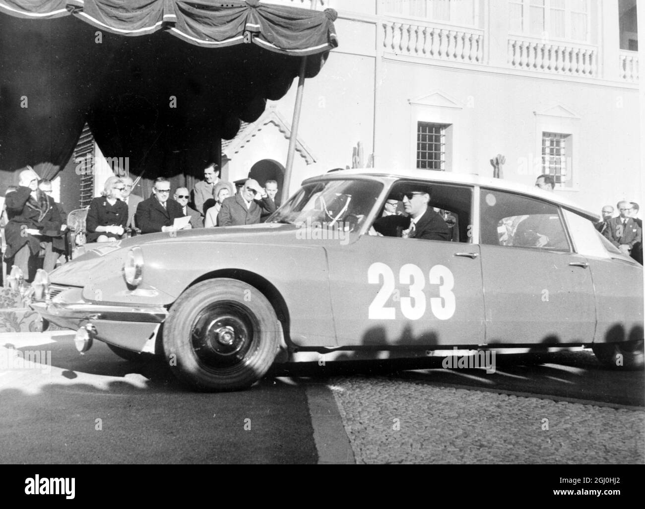 Monte Carlo, Citroen car 233 and the driver and co-driver P. Toivonnen and A. Jarvi of Finland who gained a team prize at the presentation ceremony of the Monte Carlo Rally here on January 26th. Background left on Dais are Princess Grace and Prince Rainier (holding programme) of Monaco. 283 January 1963 Stock Photo