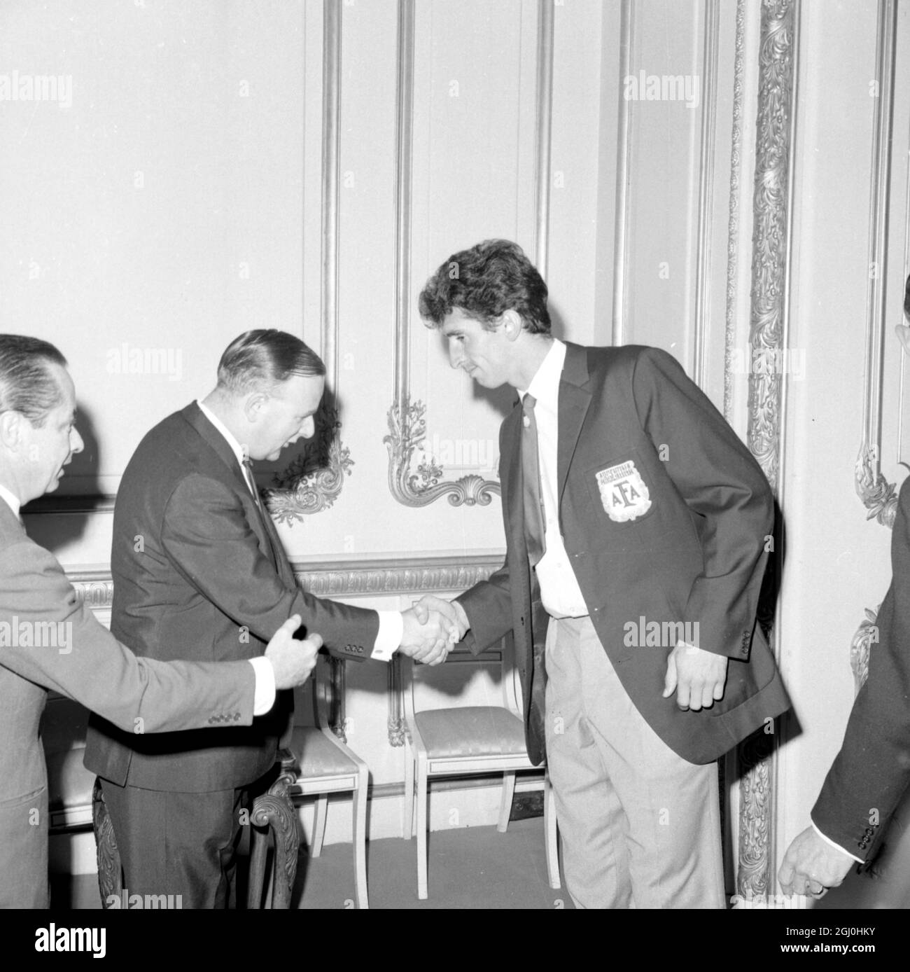 Joint Parlimentary under secretary of state for education and science Mr Denis Howell shakes hand with Argentine captain Antonio Rattin, who was sent off the pitch during game against England, at the reception given by Her Majesties Govenment to teams competing in the World Cup socccer competition, at Lancaster House, St James London 24th July 1966 Stock Photo