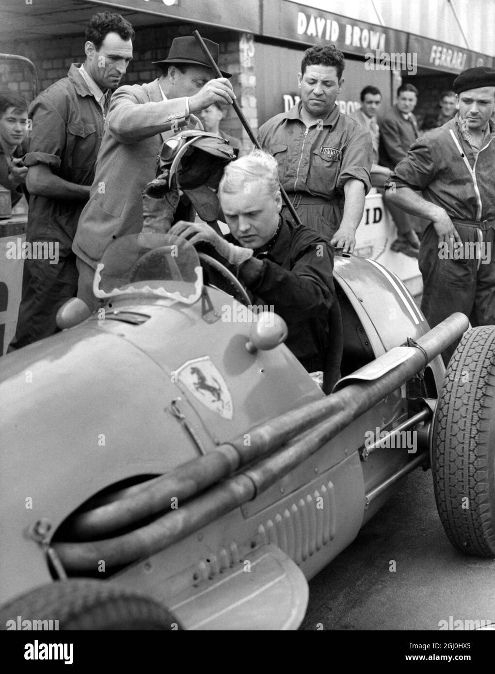Mike Hawthorn with the Ferrari he drove in the British Grand Prix at Silverstone 16th July 1954 Stock Photo