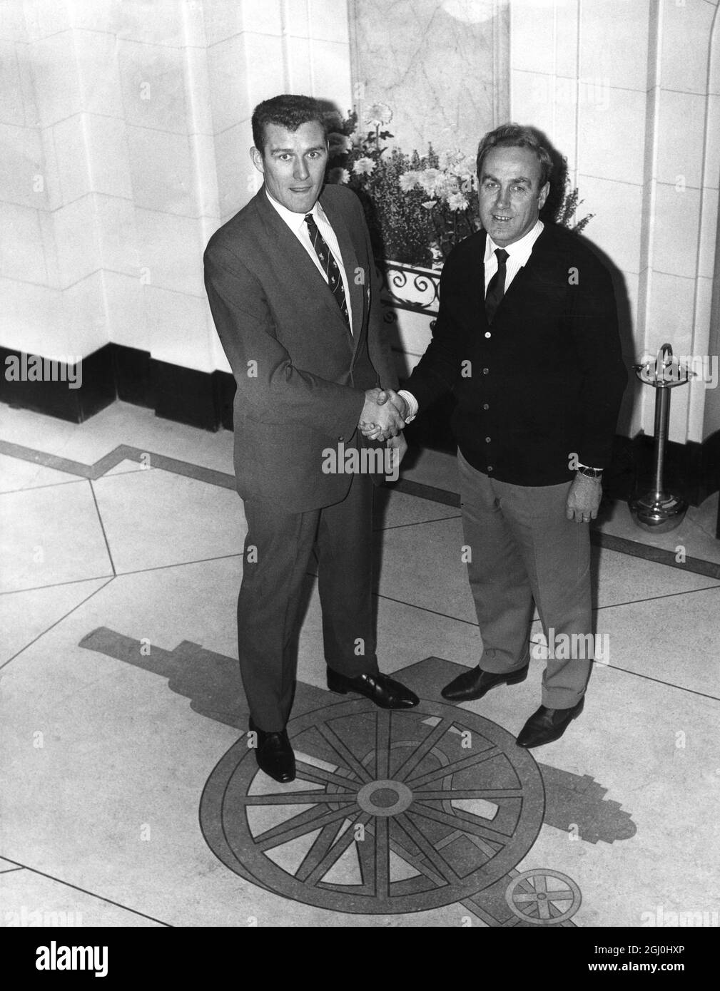 Arsenal Manager Billy Wright welcomes their new £15,000 goalkeeper James Furnell of Liverpool at the club ground at Highbury. 22nd November 1963 Stock Photo