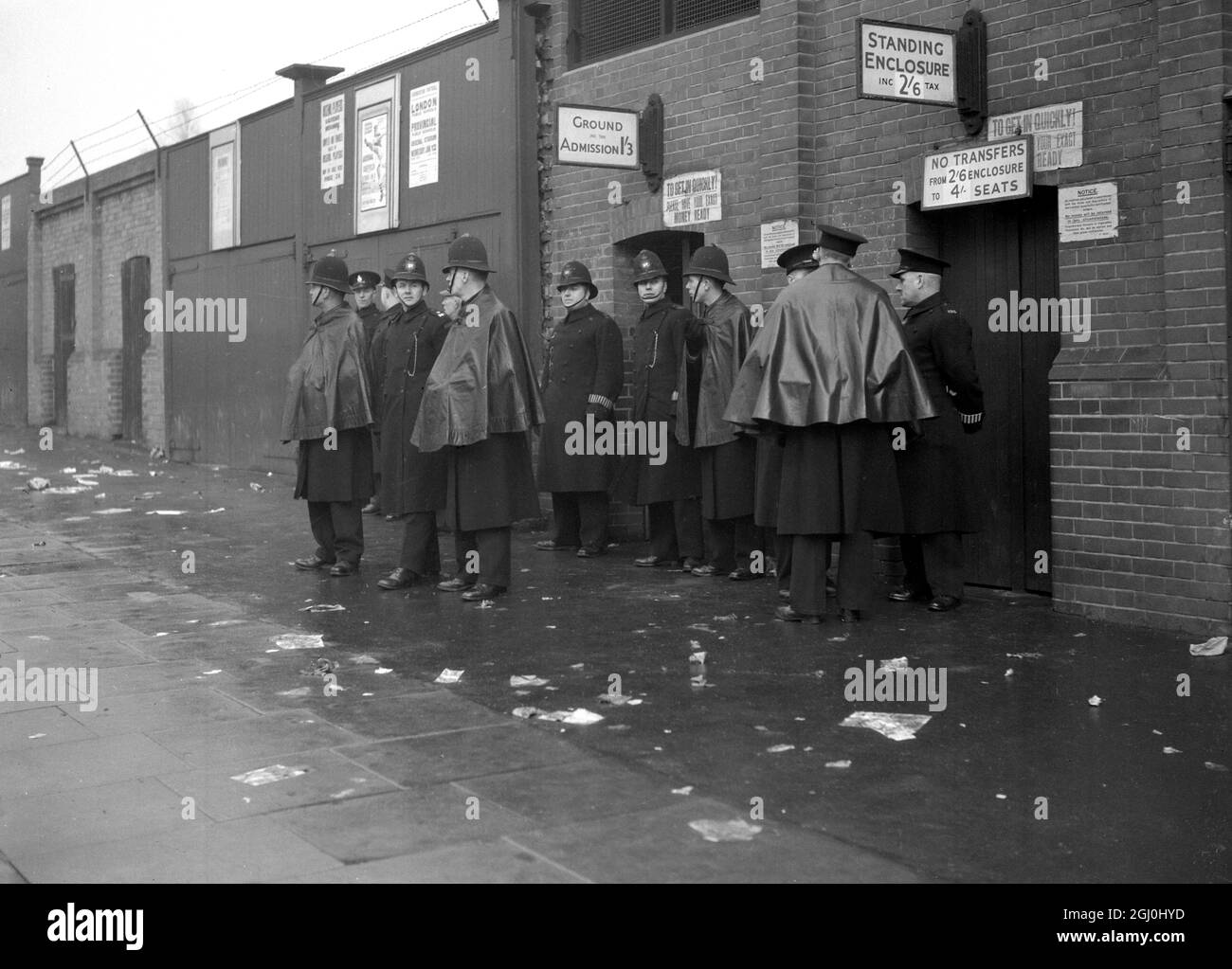 Arsenal played Tottenham Hotspurs at Highbury in the 3rd Round Cup battle , the first time these two teams have met in a Cup game Arsenal supporters improvise umbrellas as they wait the start of game. 8 January 1949 Stock Photo