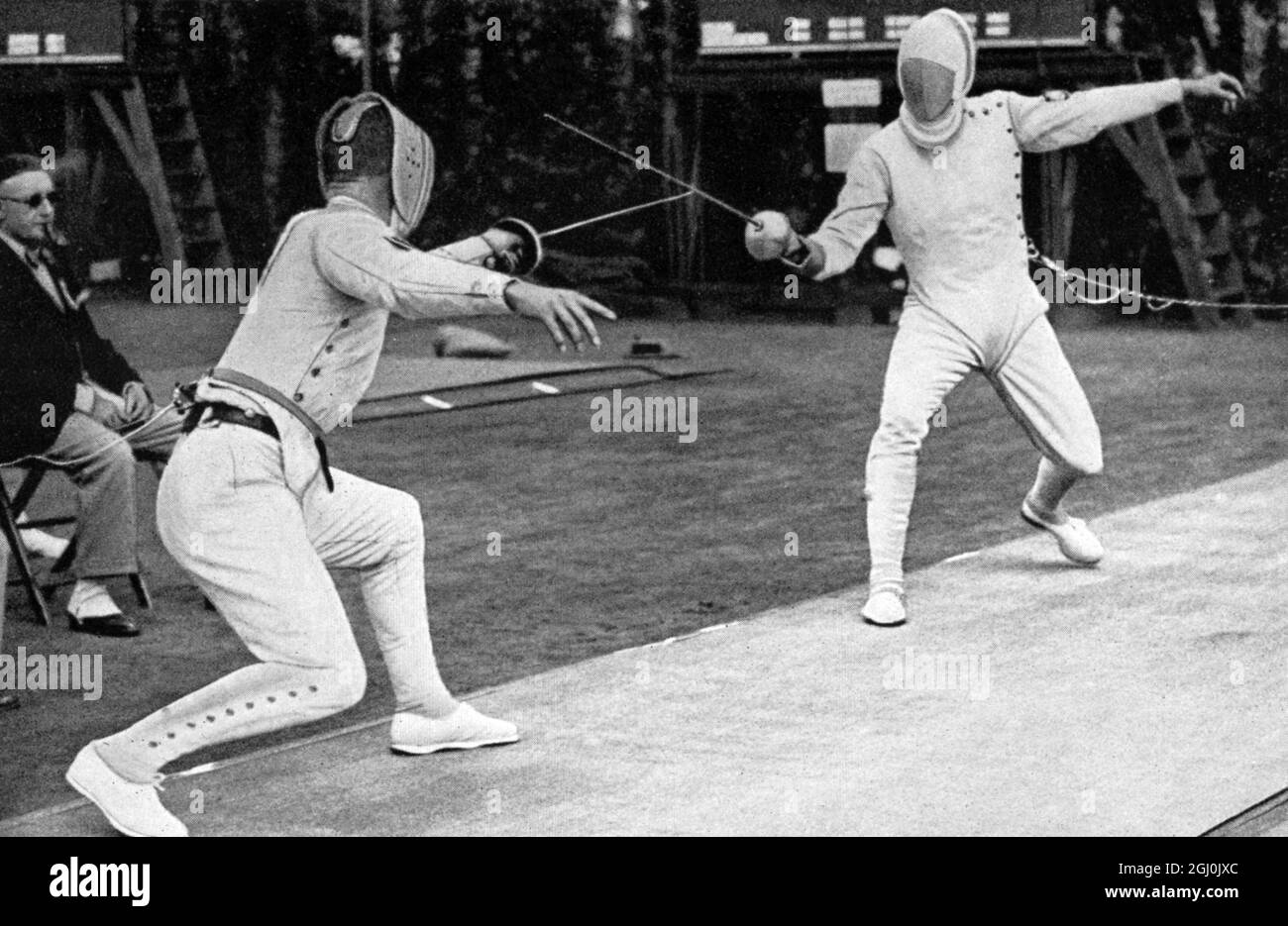 1936 Olympics, Berlin - Fencing in the Modern Pentathlon - everyone fenced against everyone. The events lasted from the morning to the late evening. Picture shows the two Germans Karl Hermann Gotthard Handrick (Gold medal Modern Pentathlon winner) and Bramfeld competing. (Im Fechten beim Funfkampf focht jeder gegen jeden. Die Gefechte dauerten von morgens bis zum spaten Abend. Die beiden Deutschen Handrick und Bramfeld im Kampf.) ©TopFoto Stock Photo