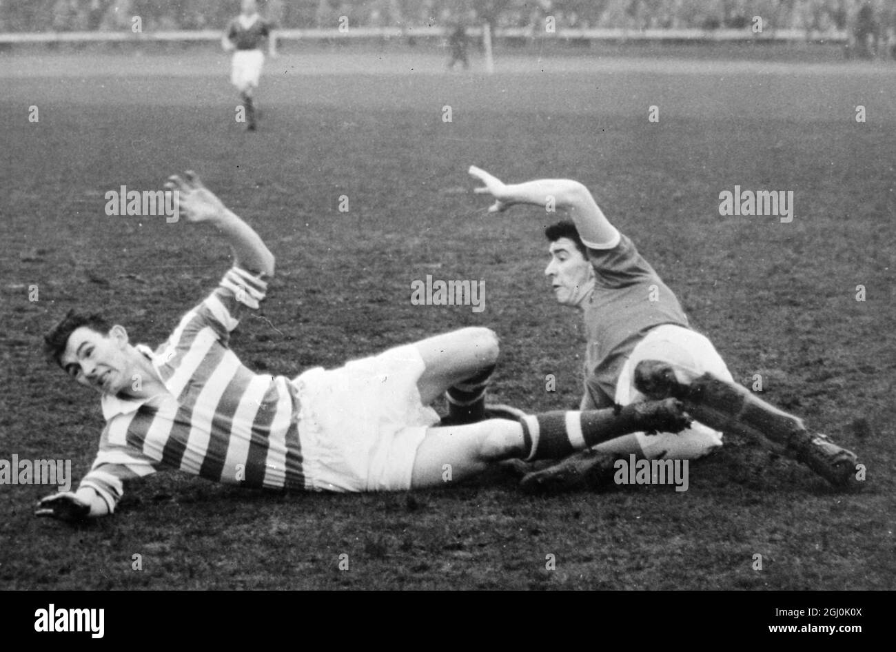 Glasgow: In the match between Celtic and Kilmanock here, Beattie of Kilmanock and Peacock of Celtic strike a ''Ballet Pose'' as they hit the ground. During a scrummage outside the Celtic goalmouth. 12 December 1955 Stock Photo