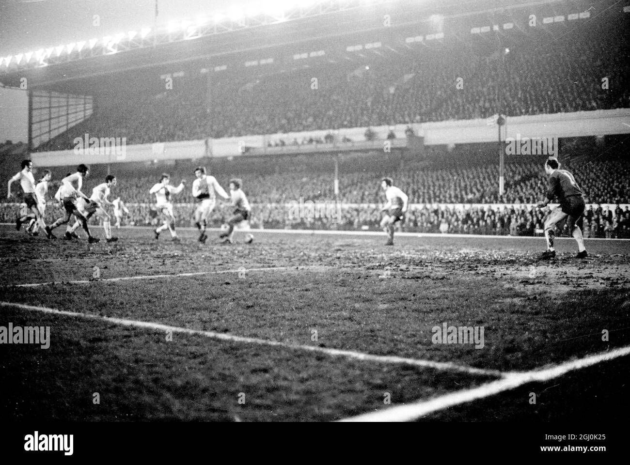 European Fairs Cup Semi-Final 1st Leg. Arsenal V Ajax Eddie Kelly of Arsenal (centre) heads the ball away during an Ajax attack in the European Fairs Cup Semi-Final at Highbury. On the extreme left is Charlie George and on the right is Frank McLintock: and extreme right (background) is Jon Sammels. 8th April 1970 Stock Photo