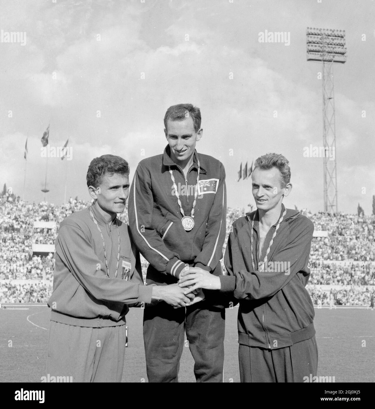 Rome Winners of the 1,500 metres event have a three way handshake on