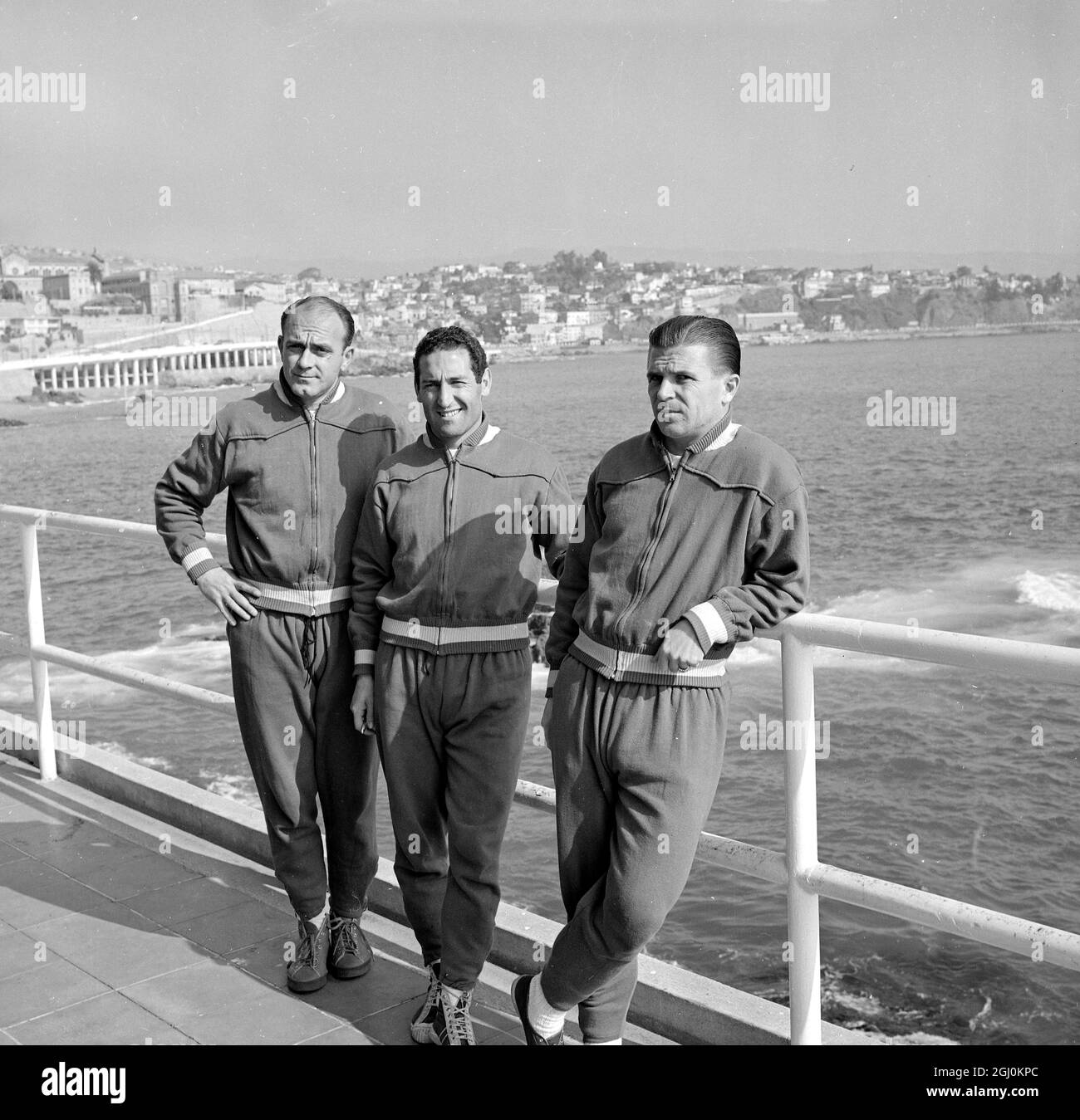 Vina Del Mar, Chile: Three of the principal footballers in European soccer today sun themselves on the promenade at Vina Bell Mar, Chile. Left to right, they are Alfredo Di Stefano; Francisco Gento, and Ferenc Puskas, all members of the Spanish National Football Team now in training for the opeening of the World Cup Soccer Tournament. 27 May 1962 Stock Photo