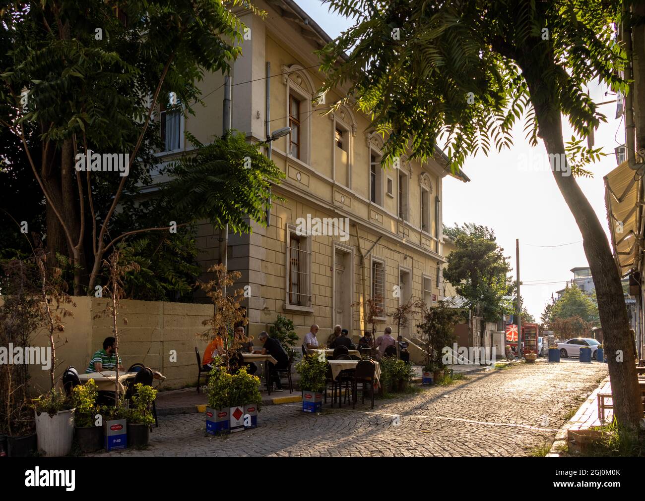 Kumkapi, Fatih, lstanbul - Turkey - August 30 2021: People sitting in a street coffee shop in Kumkapı Stock Photo