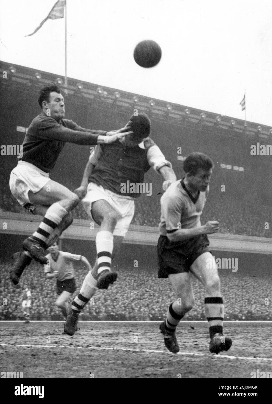 London England Arsenal at Highbury Vs Wolves who add two more points to their chances of winning the 1957-1958 Season League Championship . Kelsey of Arsenal punches clear centre Wills and wolves Deeley . 7 April 1958 Stock Photo