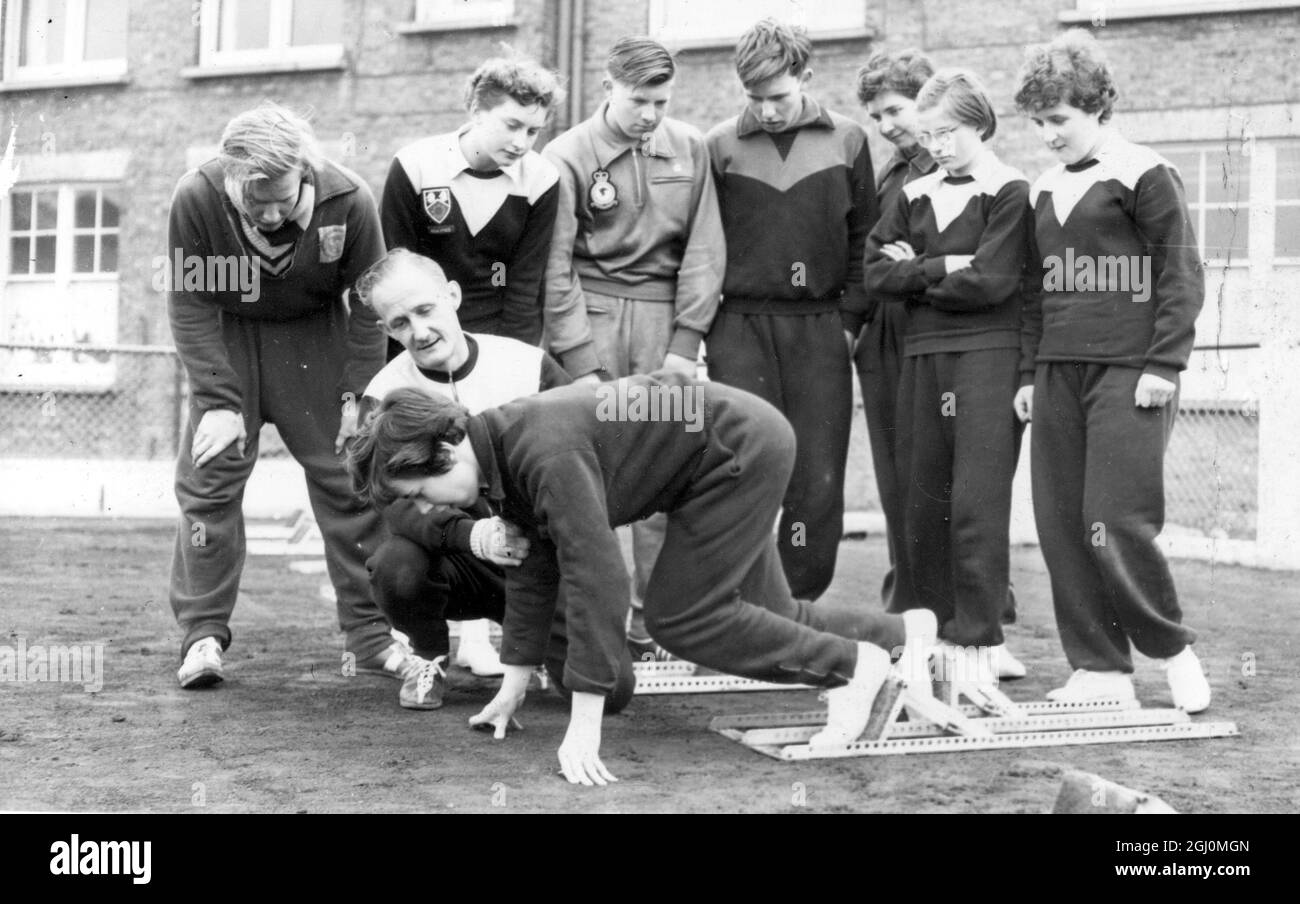Three day course for young athletes from school all over Surrey has opened at London University Sports Ground at Motspur Park Surrey . 15 year old Pamela Mayo of Redhill and Reigate Athletic Club receives instruction on the starting blocks from coach Peter Elphick . 9 April 1958 Stock Photo