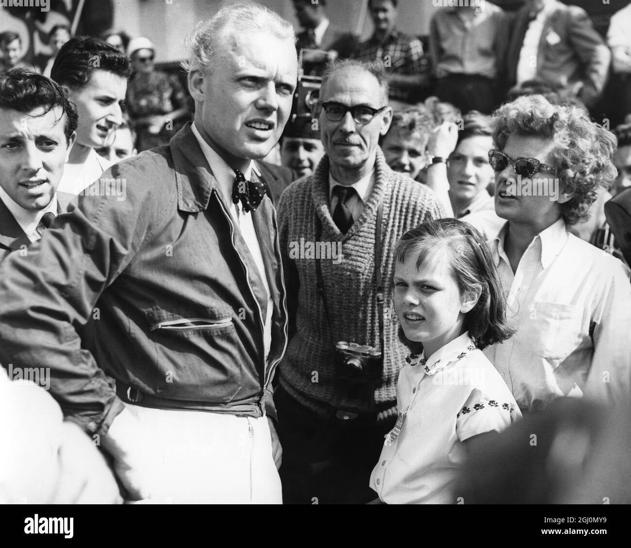 Mike Hawthorn surrounded by spectators after finishing second behind Collins and thus going to the front of the World Championship table . 19 July 1958 Stock Photo