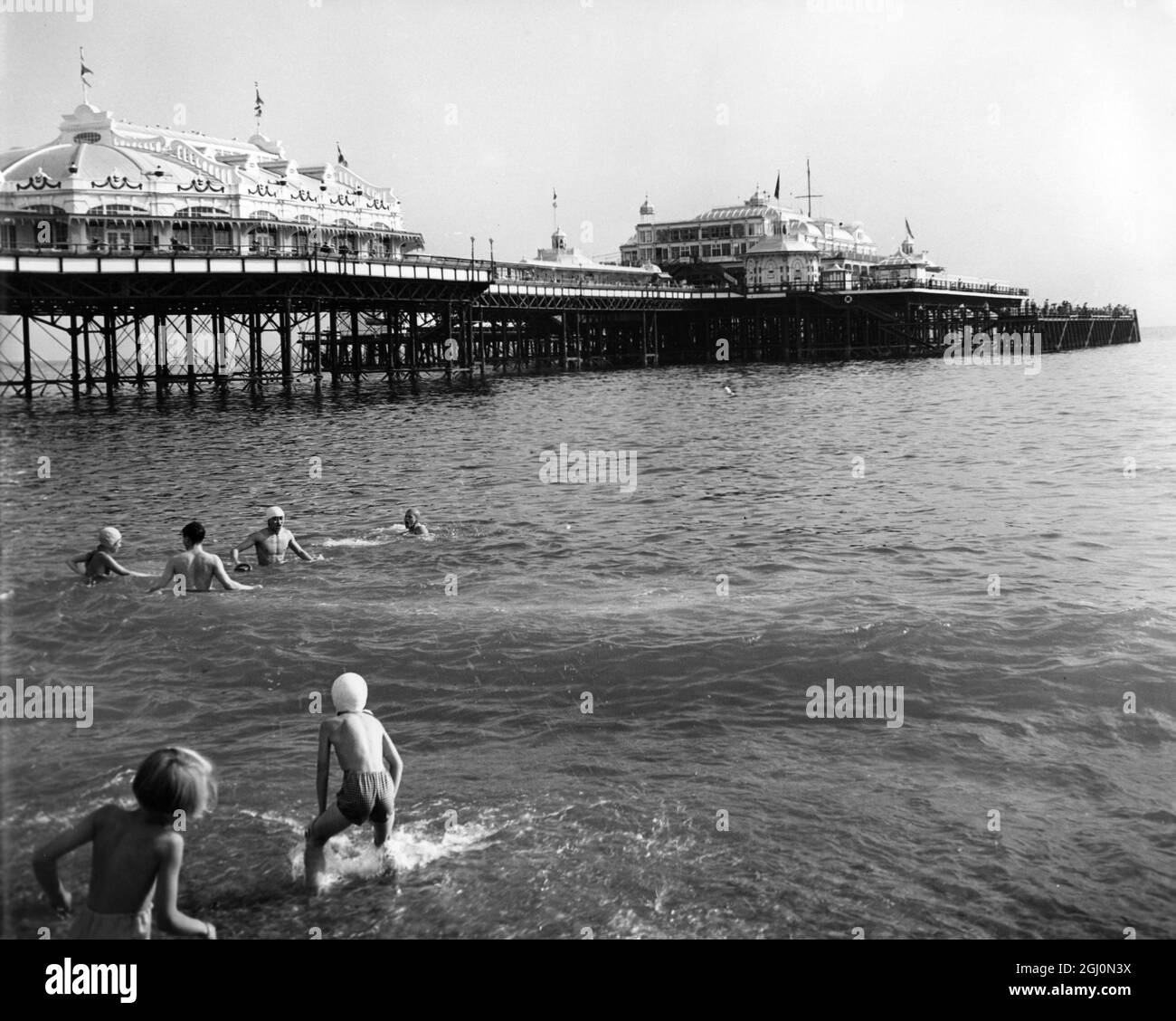 Brighton - enjoying paddling and swimming in the sea near the pier Stock Photo