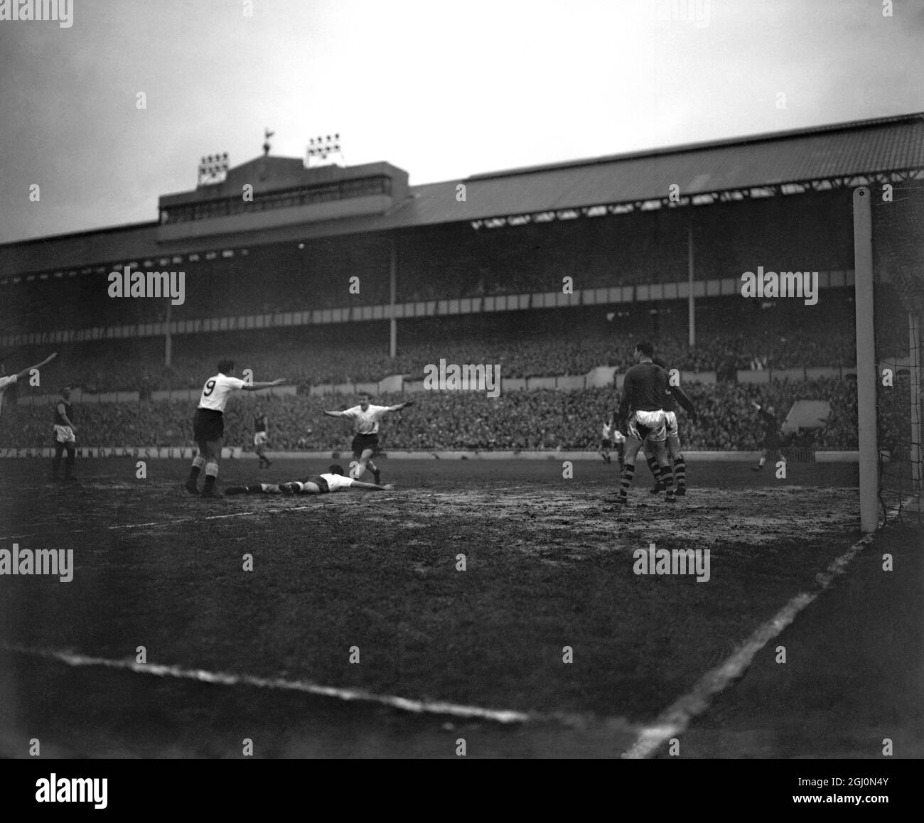 Tottenham Hotspurs Half-back Norman is pictured lying full length on the ground this afternoon after scoring the Spurs first goal in the match they played against Burnley at the Tottenham ground Result Spurs 4 Burnley 4 3 December 1960 Stock Photo