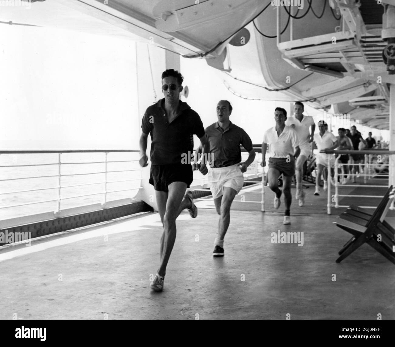 Members of the MCC Touring Team , on board the P & O Orient liner Canberra , on their way to Australia . Gordon Pirie , who is helping the team to get into peak physical conditions , leads the team for a run round the deck of the Canberra . 9 October 1962 Stock Photo