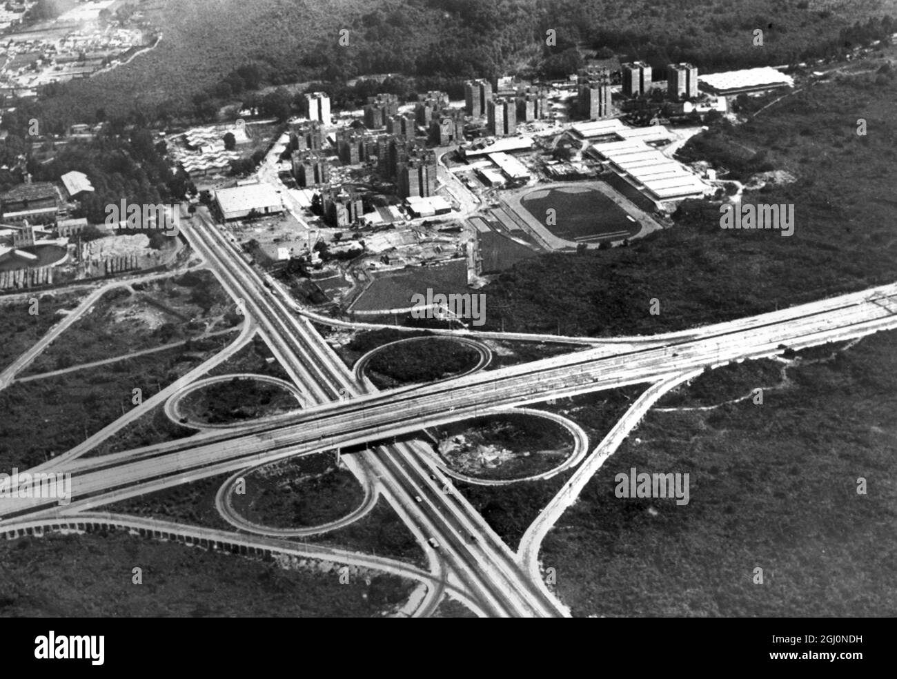 Mexico City : Modern highways flank the Olympic Village in this aerial photo , where many competing athletes will live , and practise while participating in the forthcoming 1968 Olympic Games . The white - roofed building at the extreme upper right corner is the Press Centre . The multiple - laned highway is Insurgentes Avenue . 15th August 1968 Stock Photo