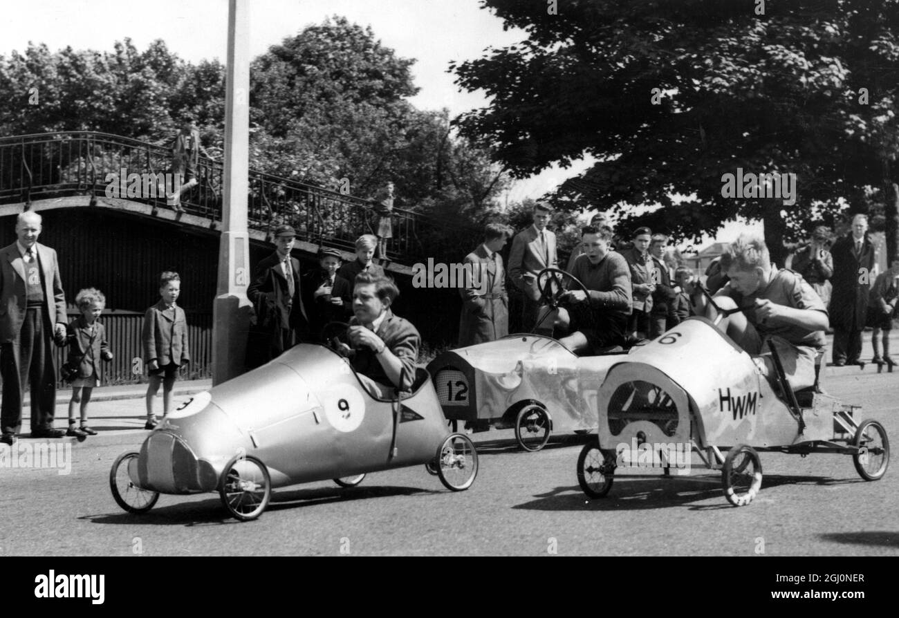 232623-F London - in their homemade cars, Boy Scouts come flashing down Olympic Way Wembley in the London and Home Counties semi-finals of the Boy Scouts' Soap Box Derby 7 June 1952 Stock Photo
