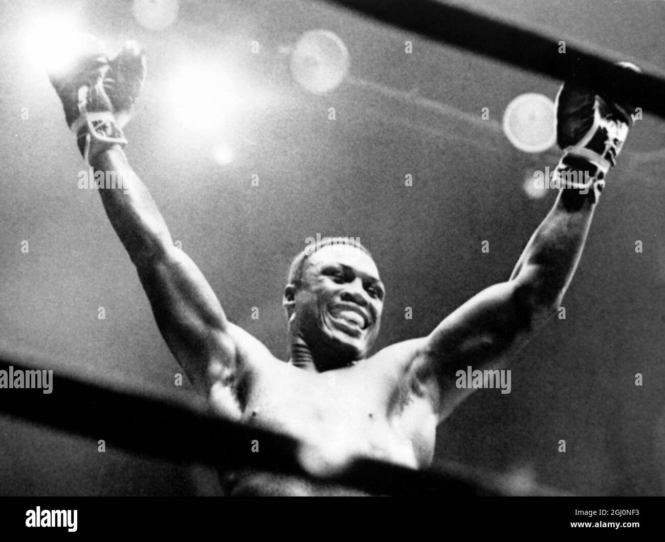 Joe Frazier raises his victory after his scheduled 12-round fight against Canada's George Chuvalo was stopped in the fourth round at Madison Square Garden. Frazier slashed open the Canadian heavyweight's face with a barrage of blows , forcing the referee to stop the fight. 20th July 1967 Stock Photo