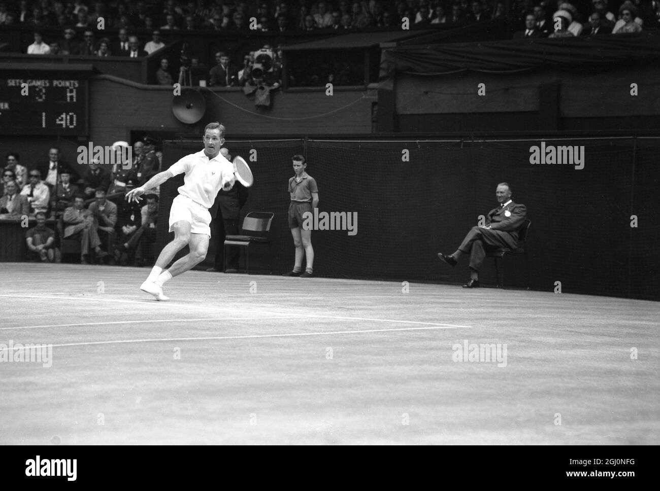 Reigning Wimbledon champion , Rod Laver , of Australia , in action against compatriot , 21 year old Martin Mulligan in the Men's Singles Final of the All England Lawn Tennis Championships at Wimbledon this afternoon . Laver completed the Grand Slam last achieved by Donald Budge in 1938 , the Australian , French , Wimbledon and United States Championships . Mulligan fought gallantly but Laver stormed to victory 6-2 6-2 6-1 6 July 1962 Stock Photo
