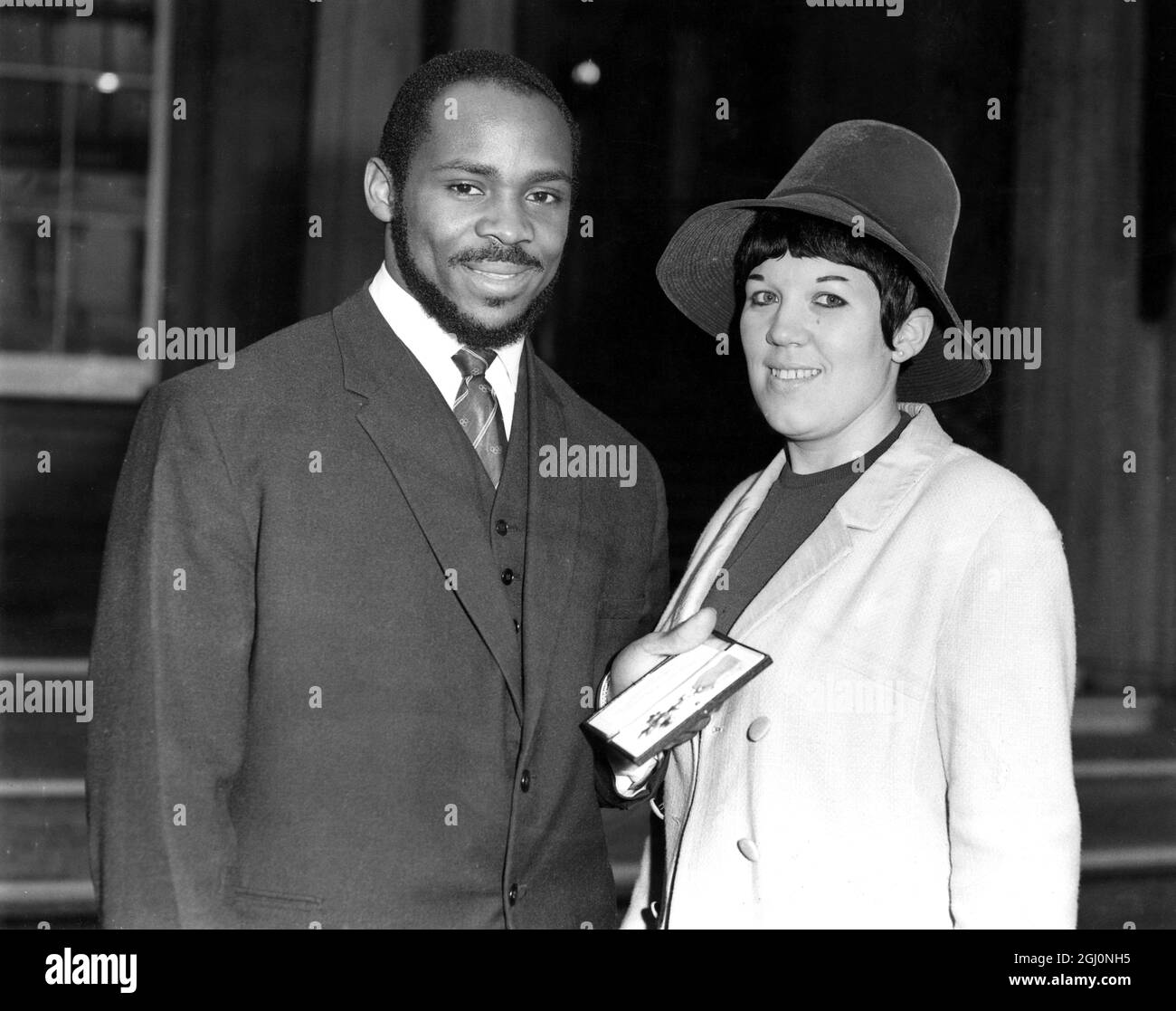 Olympic weightlifter Louis Martin , photographed with his wife outside Buckingham Palace after receiving his MBE . 5th November 1965 Stock Photo